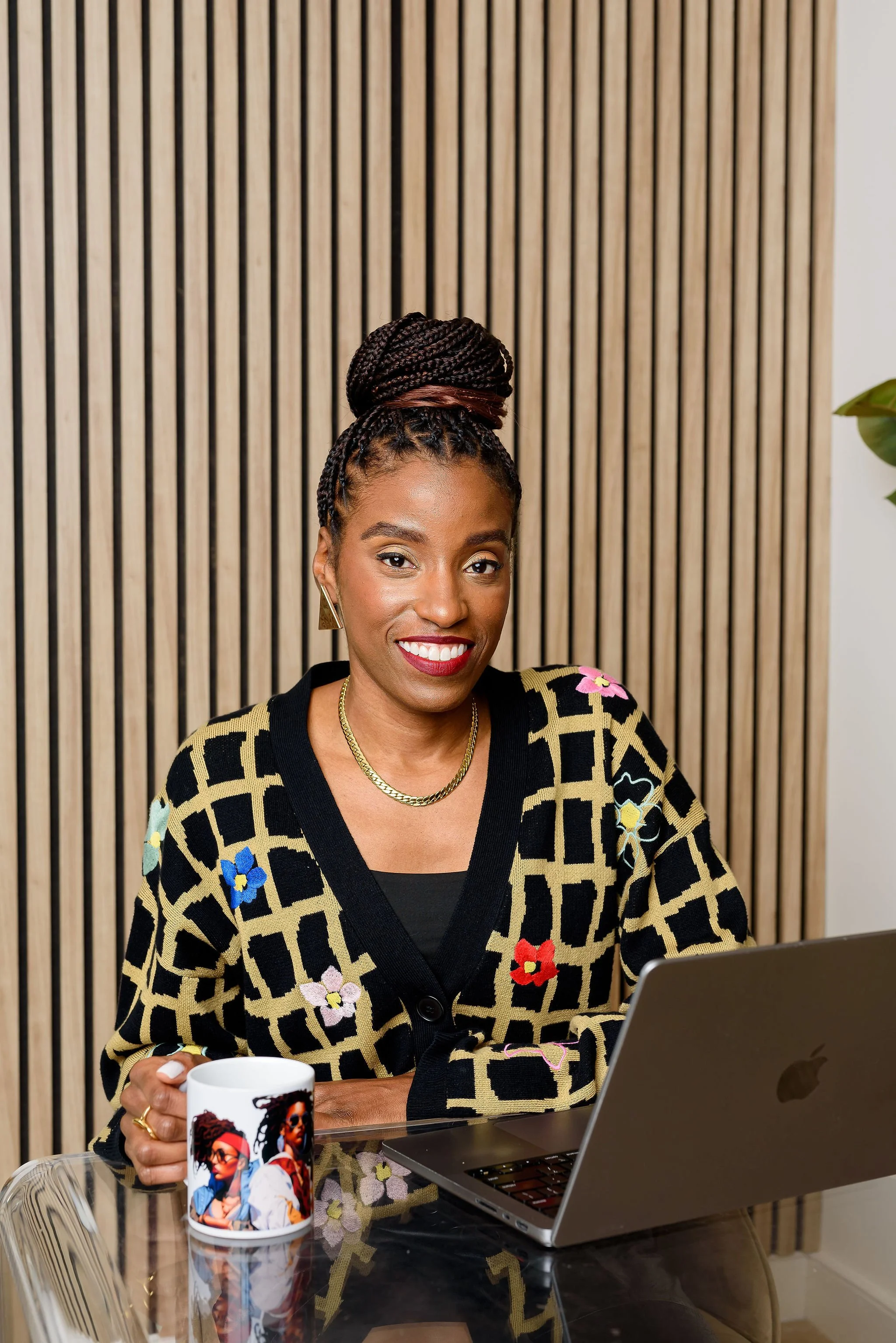Keri Henderson sitting at a desk to promote The Kickback With Keri newsletter