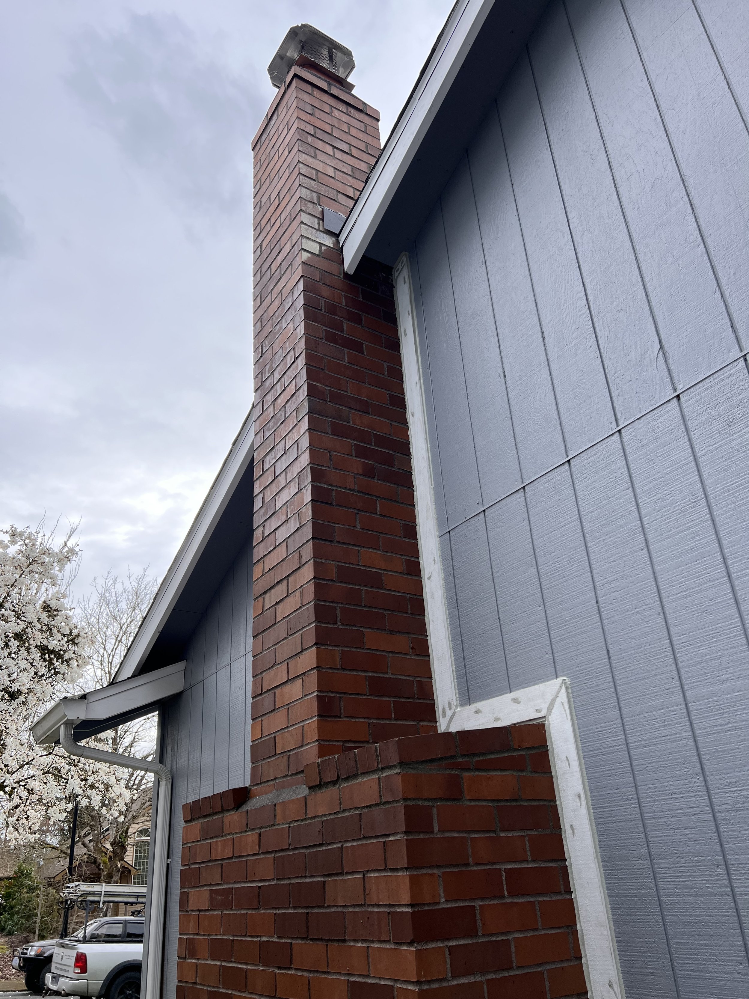 Chimney Tuckpointing, Concrete Cap Replacement, and Trim Installation