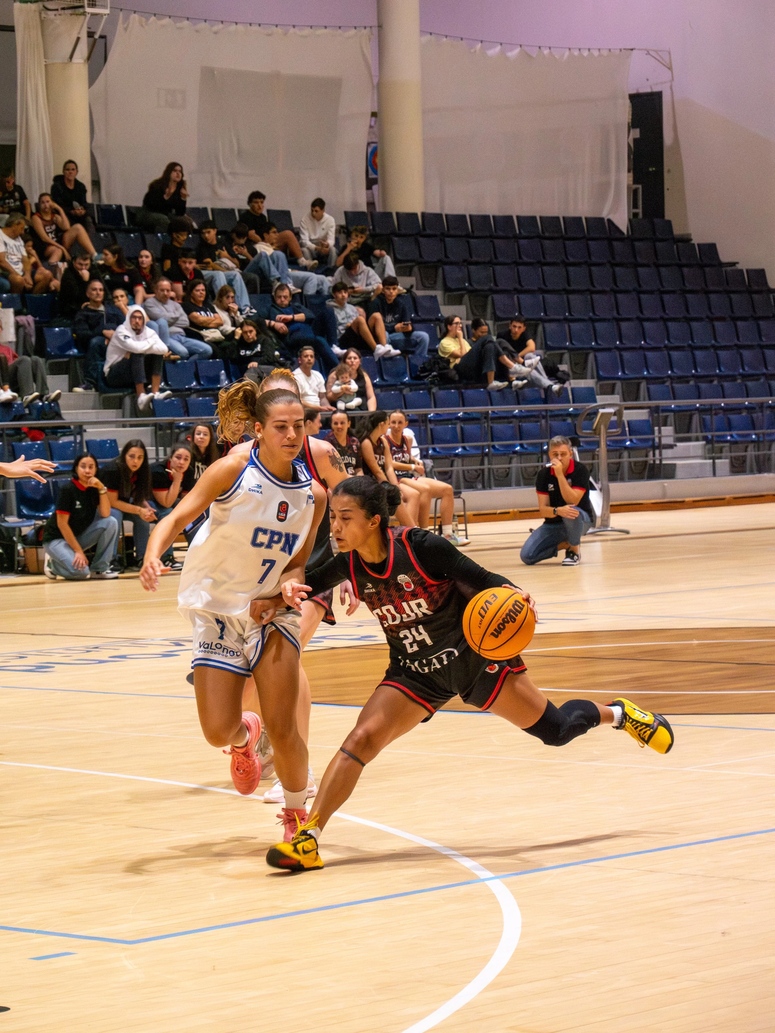San Juan making a dribble move, Female Basketball Game