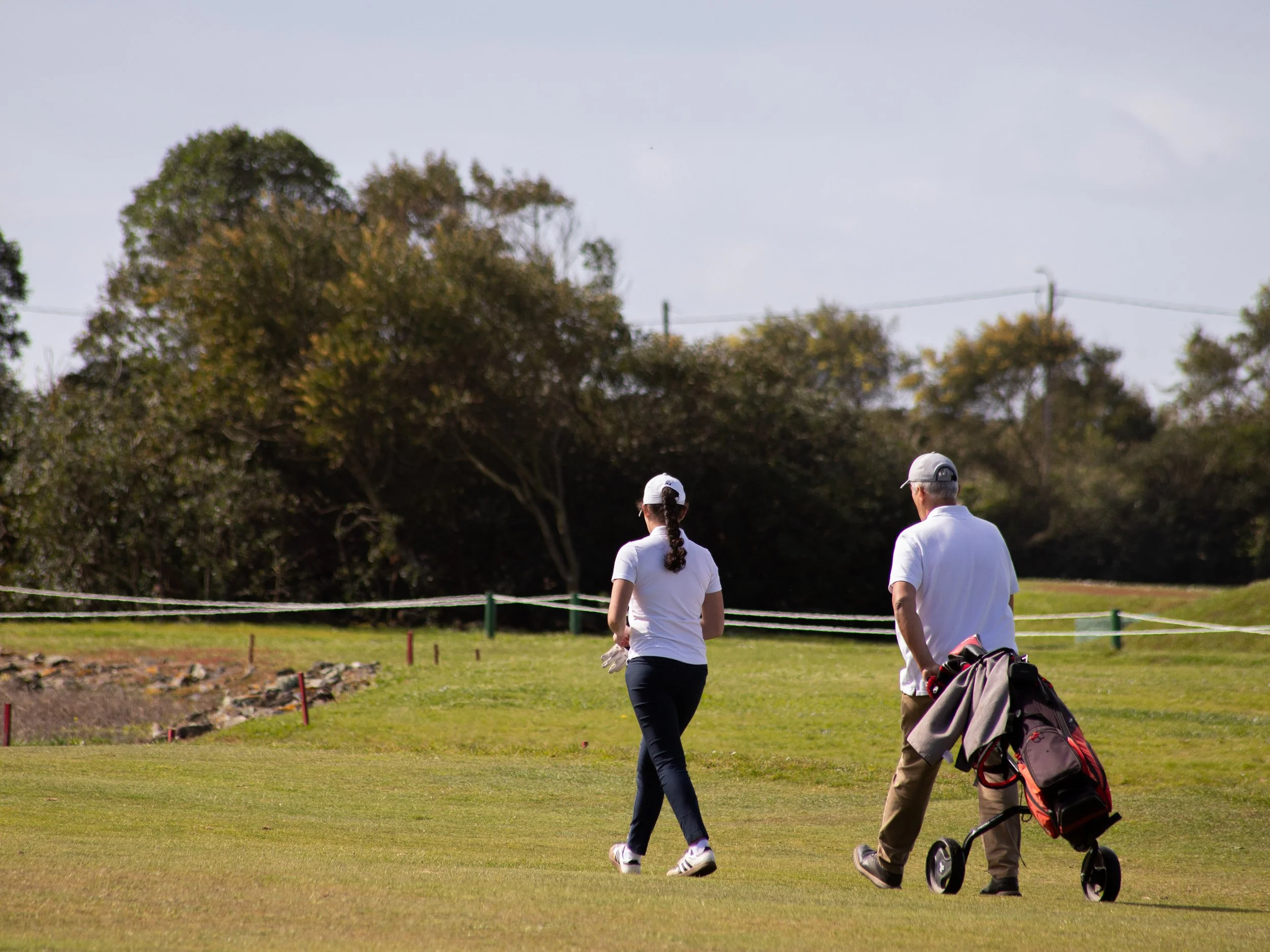 female golf player with her caddie