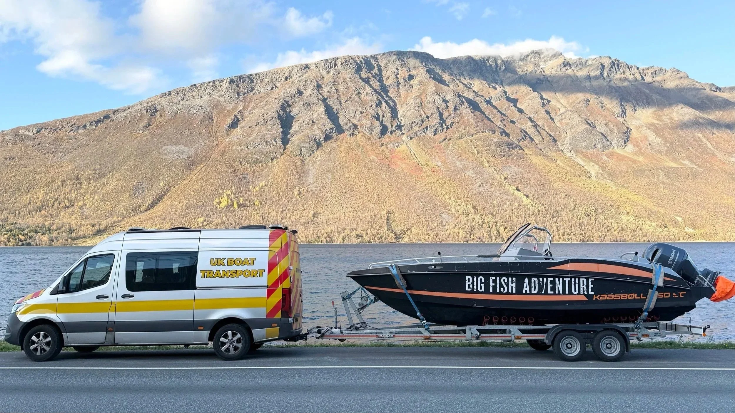 A van with a sporty motor boat on a trailer