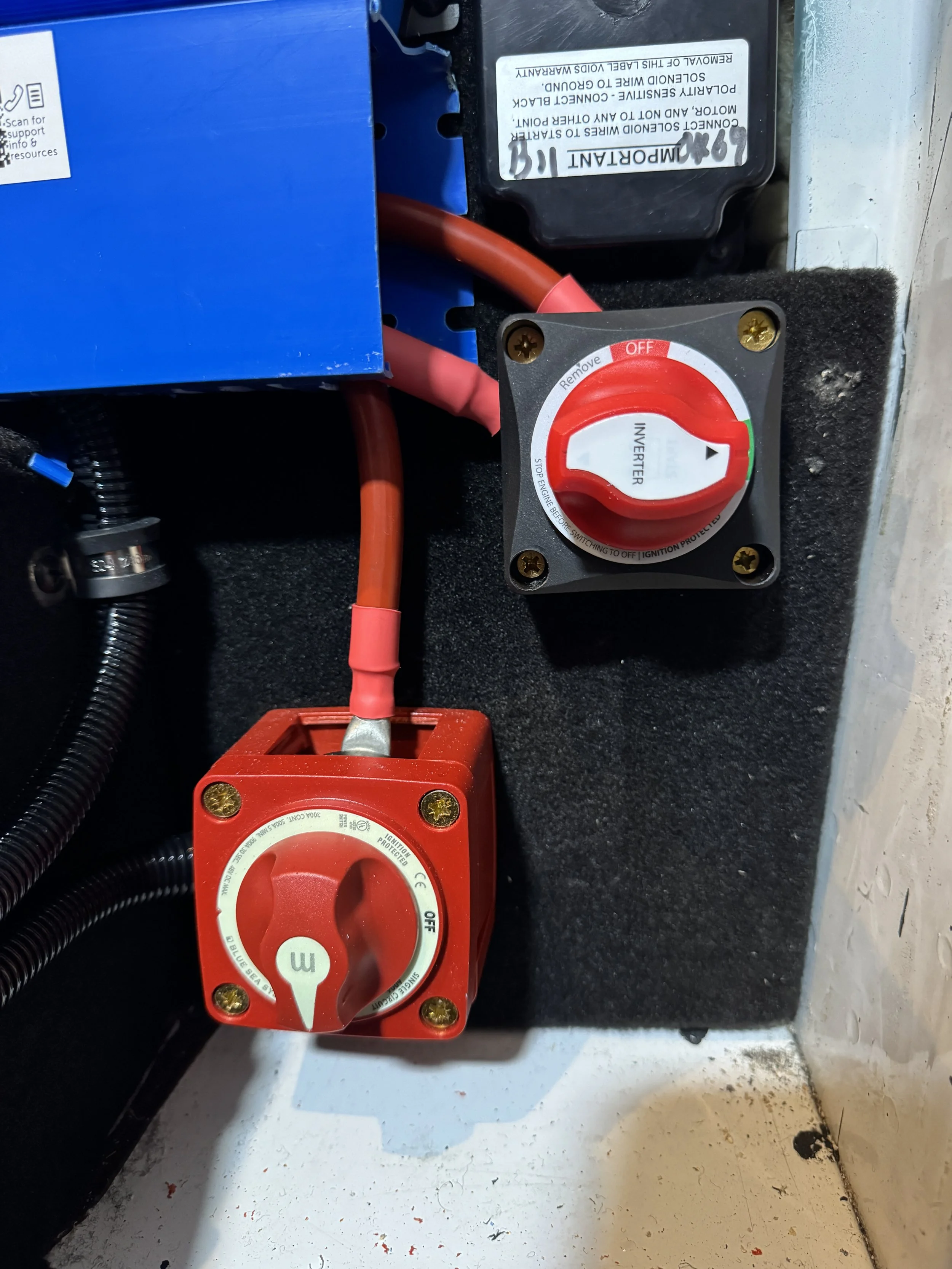 An electrical panel featuring a red breaker switch labeled '3' and a red inverter switch, with a blue box and black wiring.