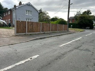 Wooden fence along the sidewalk in a residential neighborhood