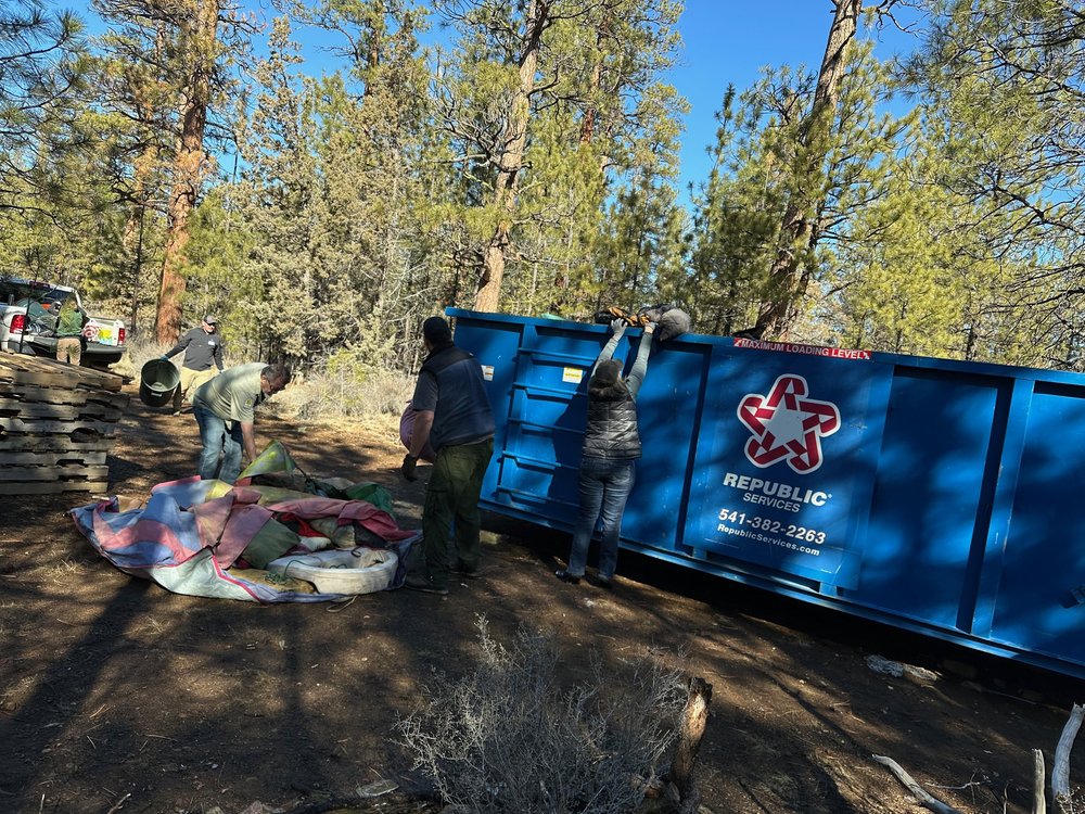 Team Effort: Loading the Dumpster