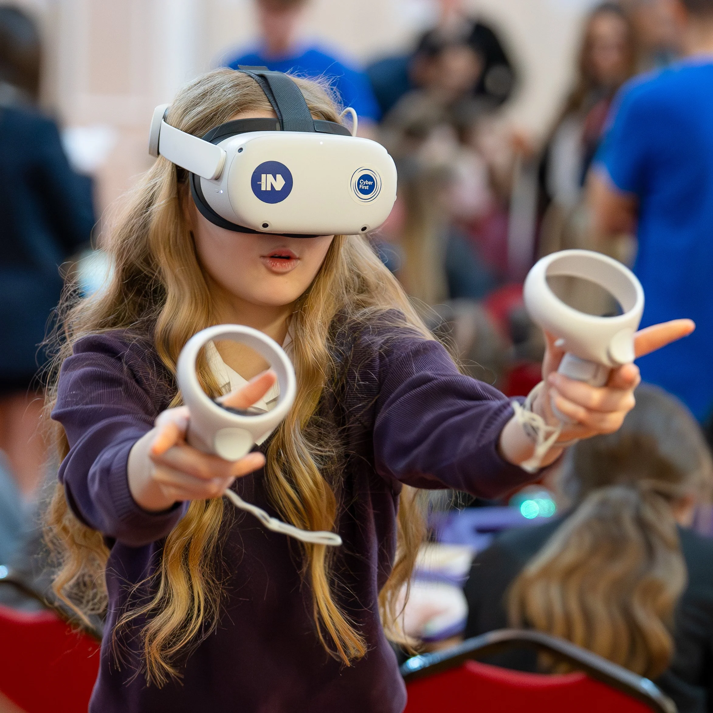 A young girl working with VR - virtual reality, at an all girl's educational event surrounding Cyber security and learning about Cyber. 