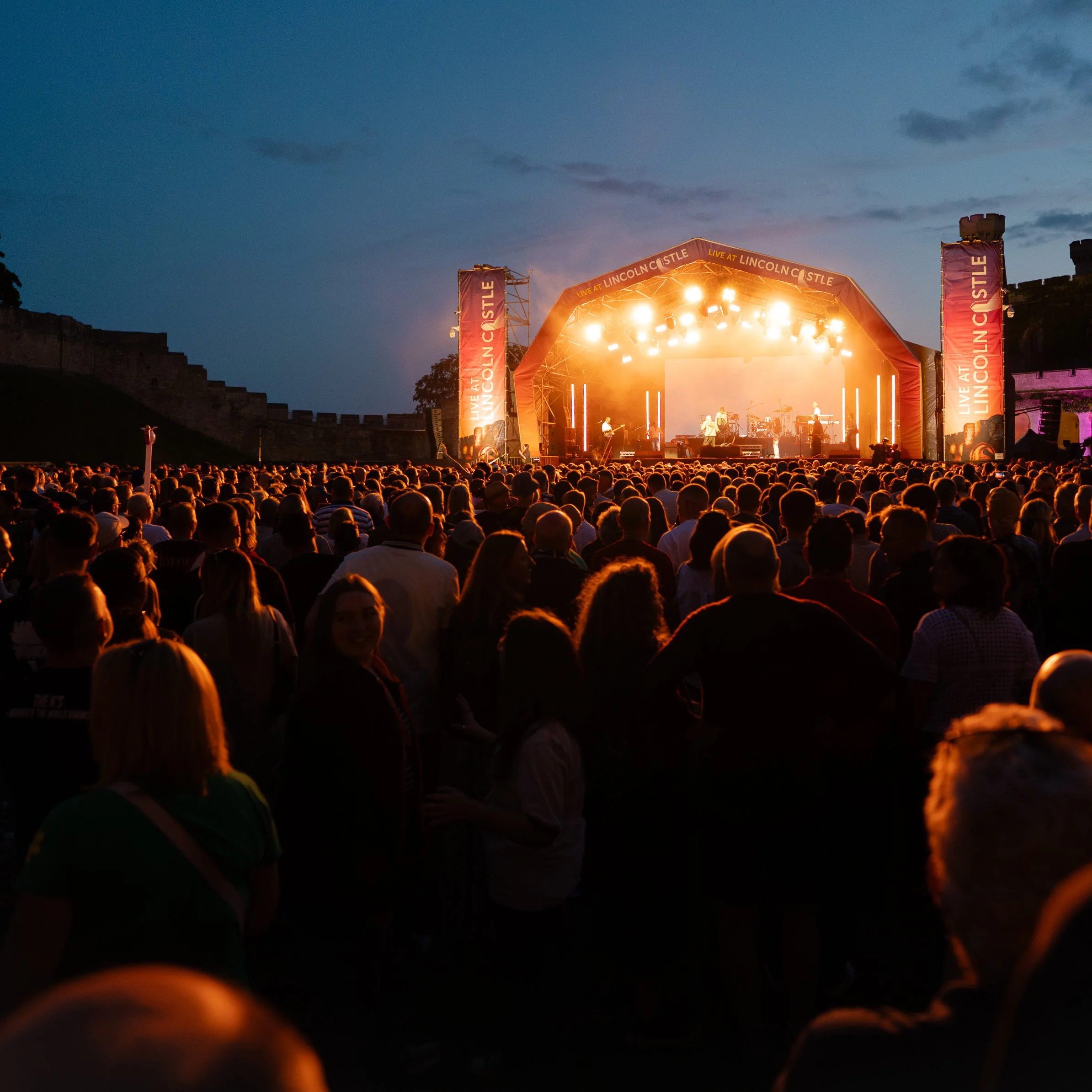 Live music festival in the summer with large crowd attendance. Music coverage.