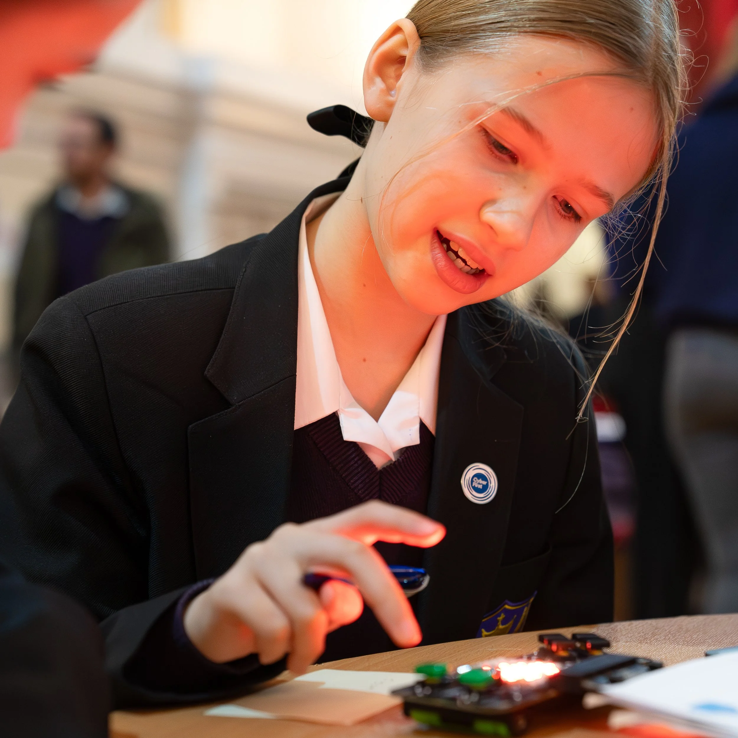 Young student at an educational fair learning science and cyber security.