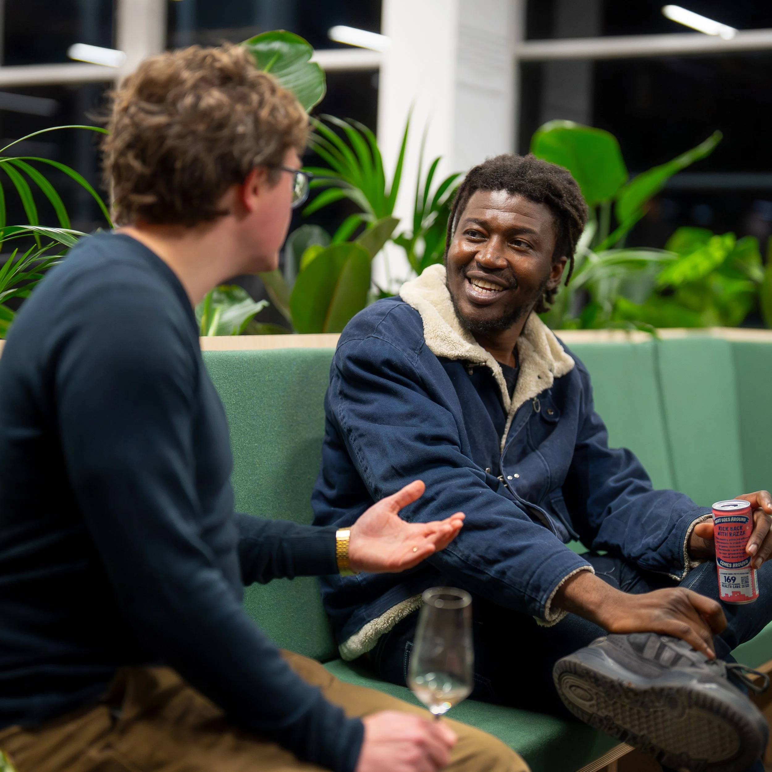 Two men chatting at a corporate networking event. Having good conversation and engaging with one another.
