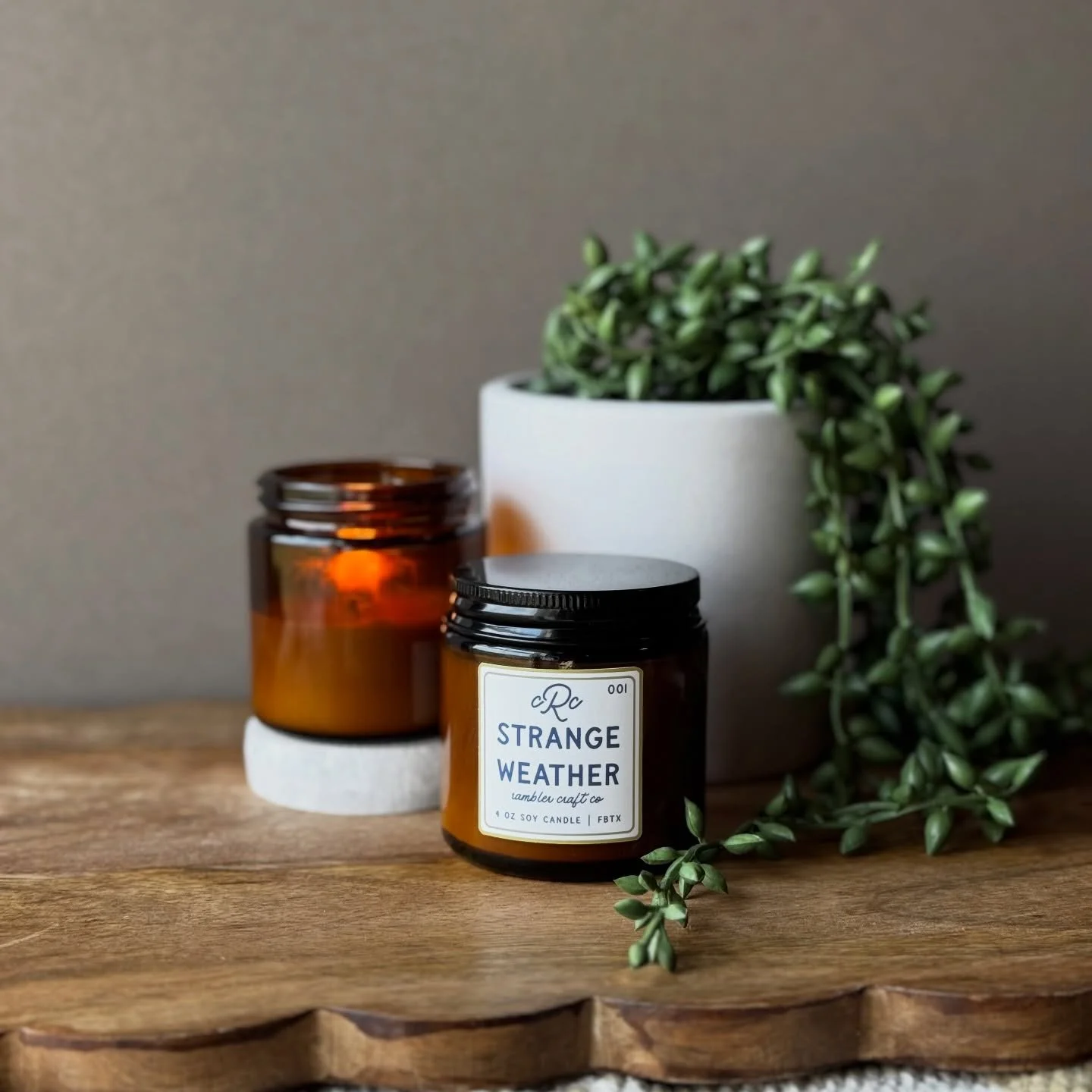 For people who consider watching a storm roll in a legitimate Sunday plan. Strange Weather: wet earth, raw wood, distant thunder. Light it. Pour something. Stay put.