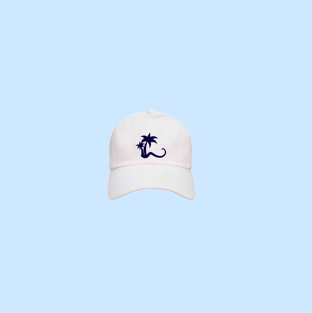 White cap with the iconic Coco Beach Ibiza logo, featuring a palm tree design, ideal for casual beachwear and sun protection.