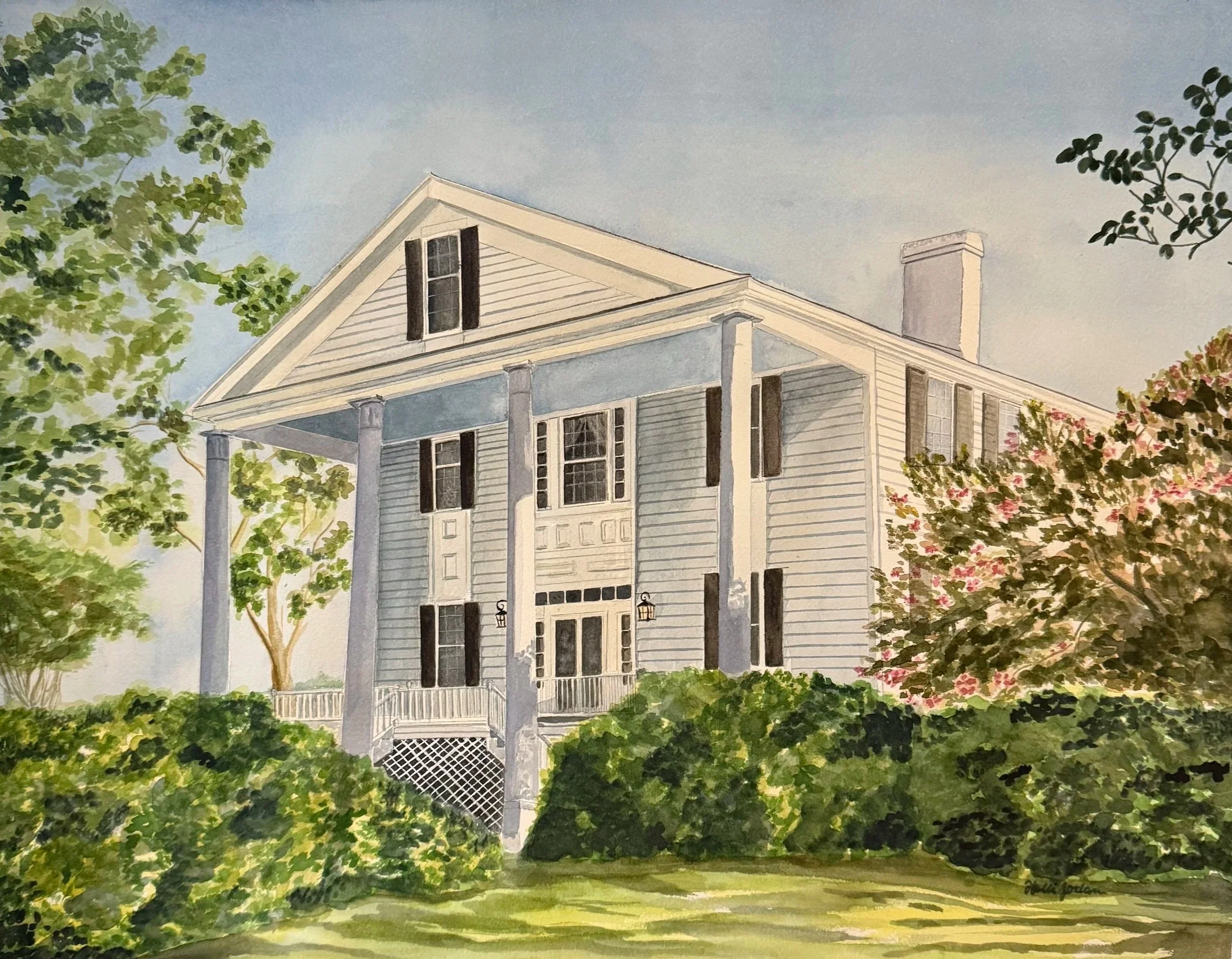 Watercolor painting of a light blue wooden house with a porch and black shutters, surrounded by green and pink flowering trees under a blue sky.