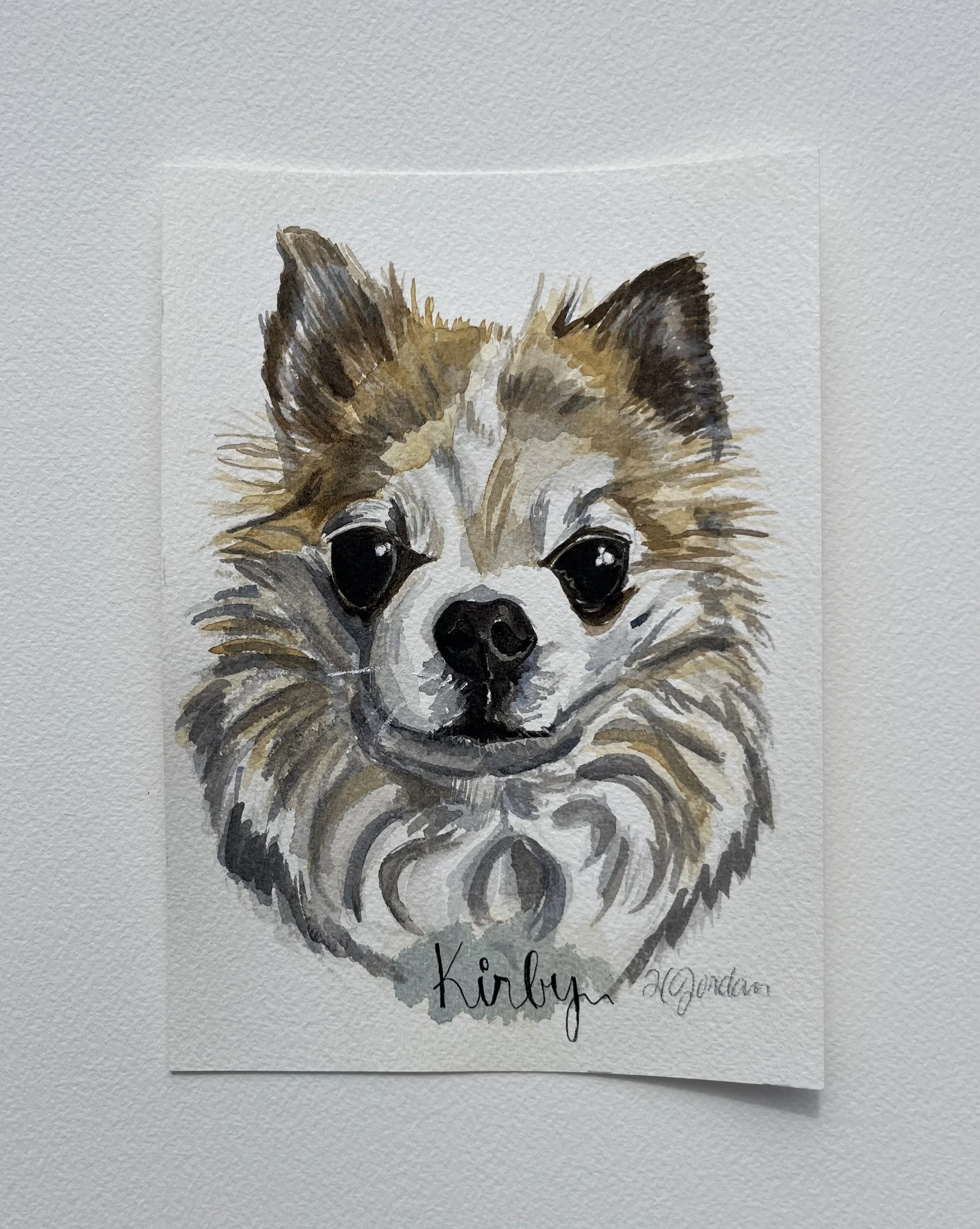 Watercolor painting of a dog's face with detailed fur, expressive eyes, and the word 'kirby' written below.