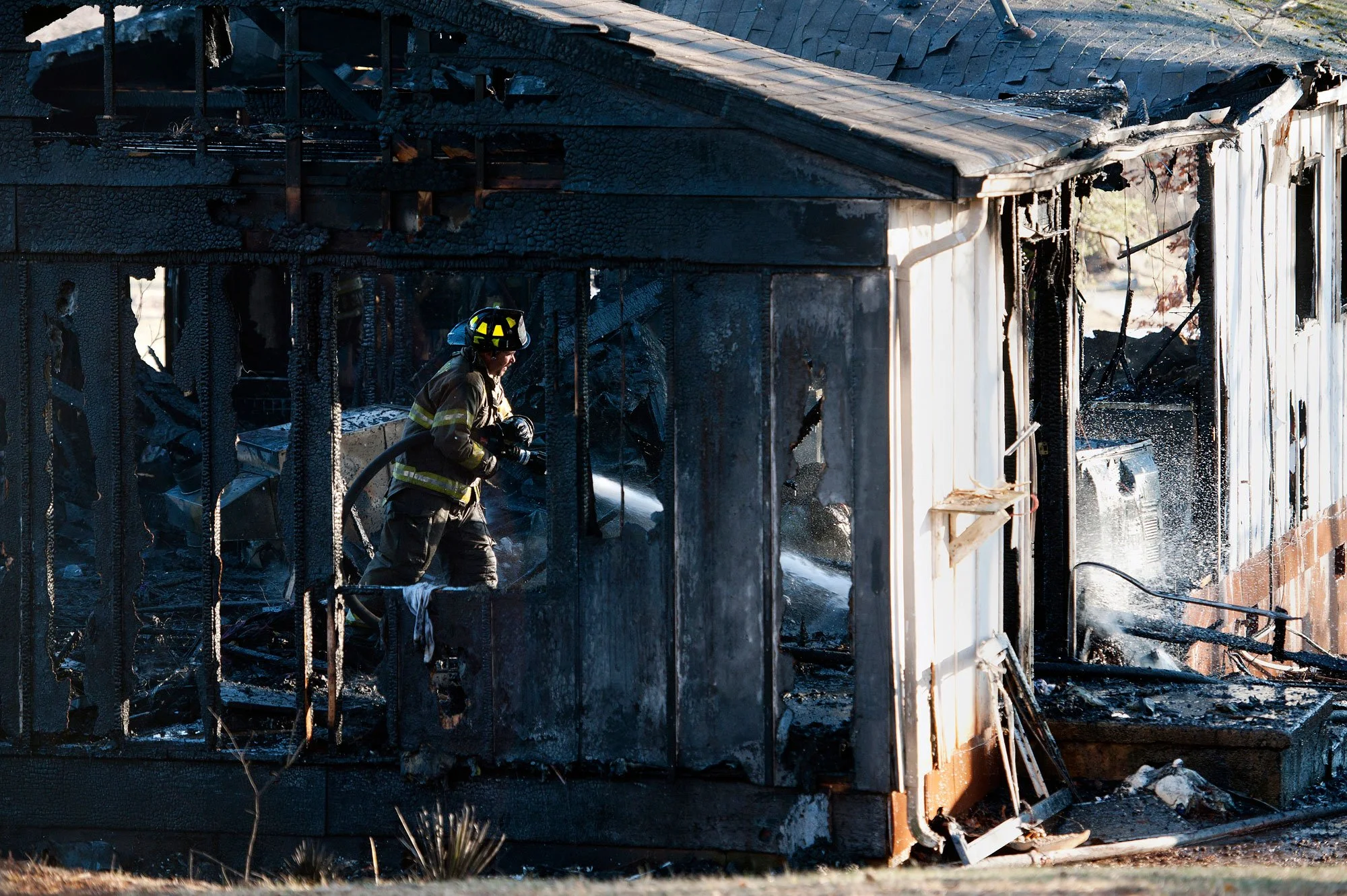 A firefighter works to extinguish the fire inside a home at 438 Thomas Road in Madison Heights on Sunday Feb. 17, 2013.