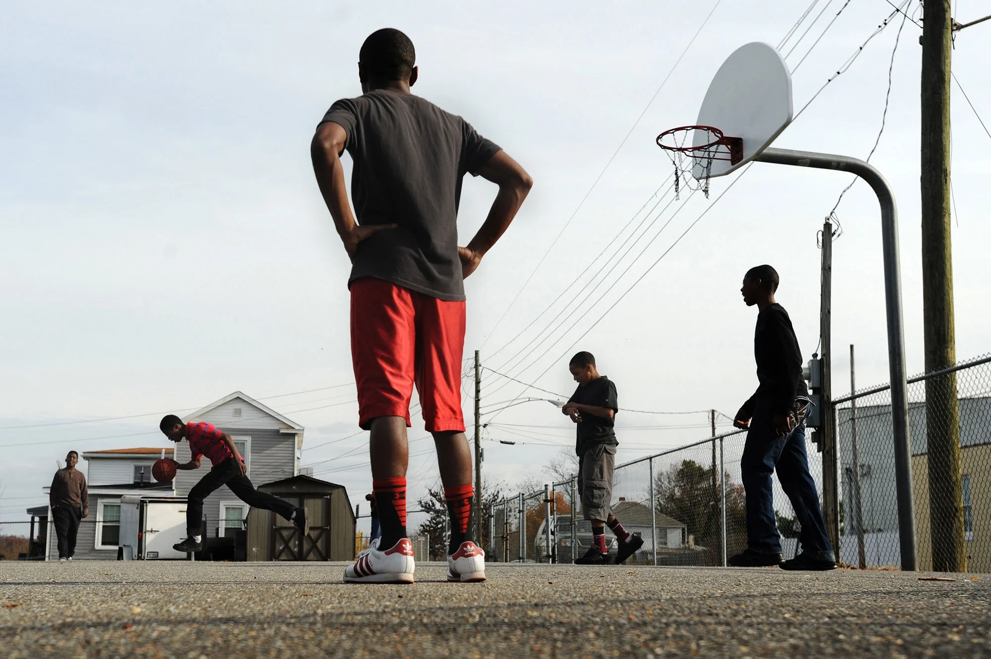 The basketball court across the street from Rivermont Avenue Baptist Church in Lynchburg is filled with friendly competition as boys gather on Sunday afternoon to shoot around in a loosely organized game. Many of the boys, though not all, participate