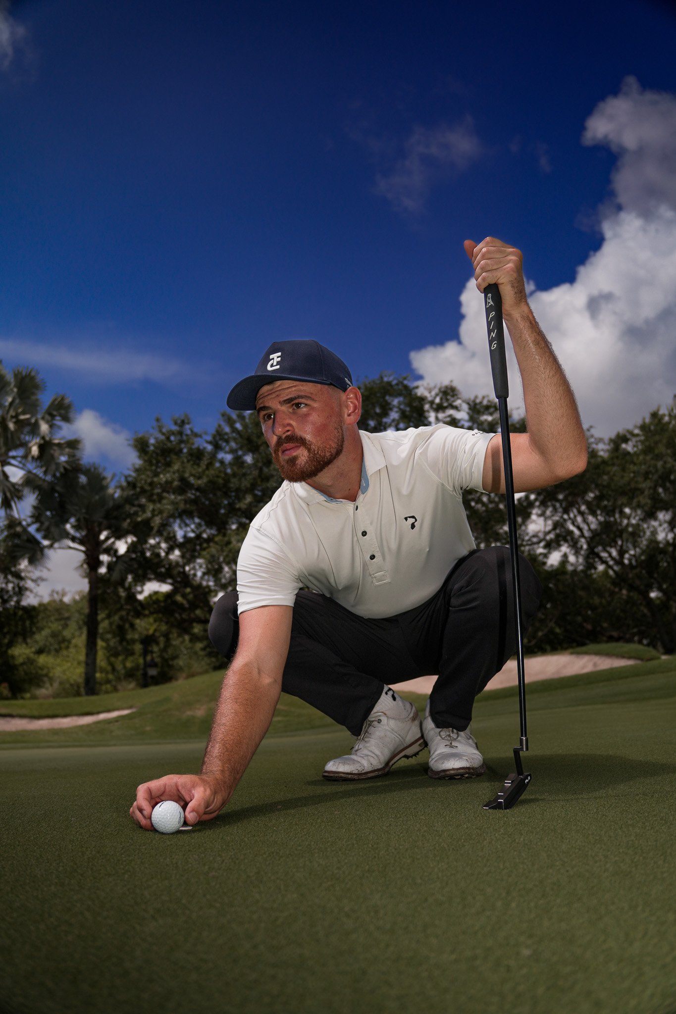 Professional golfer Hunter Goodman reading a putt during a commercial golf production captured by Threadline Collective.