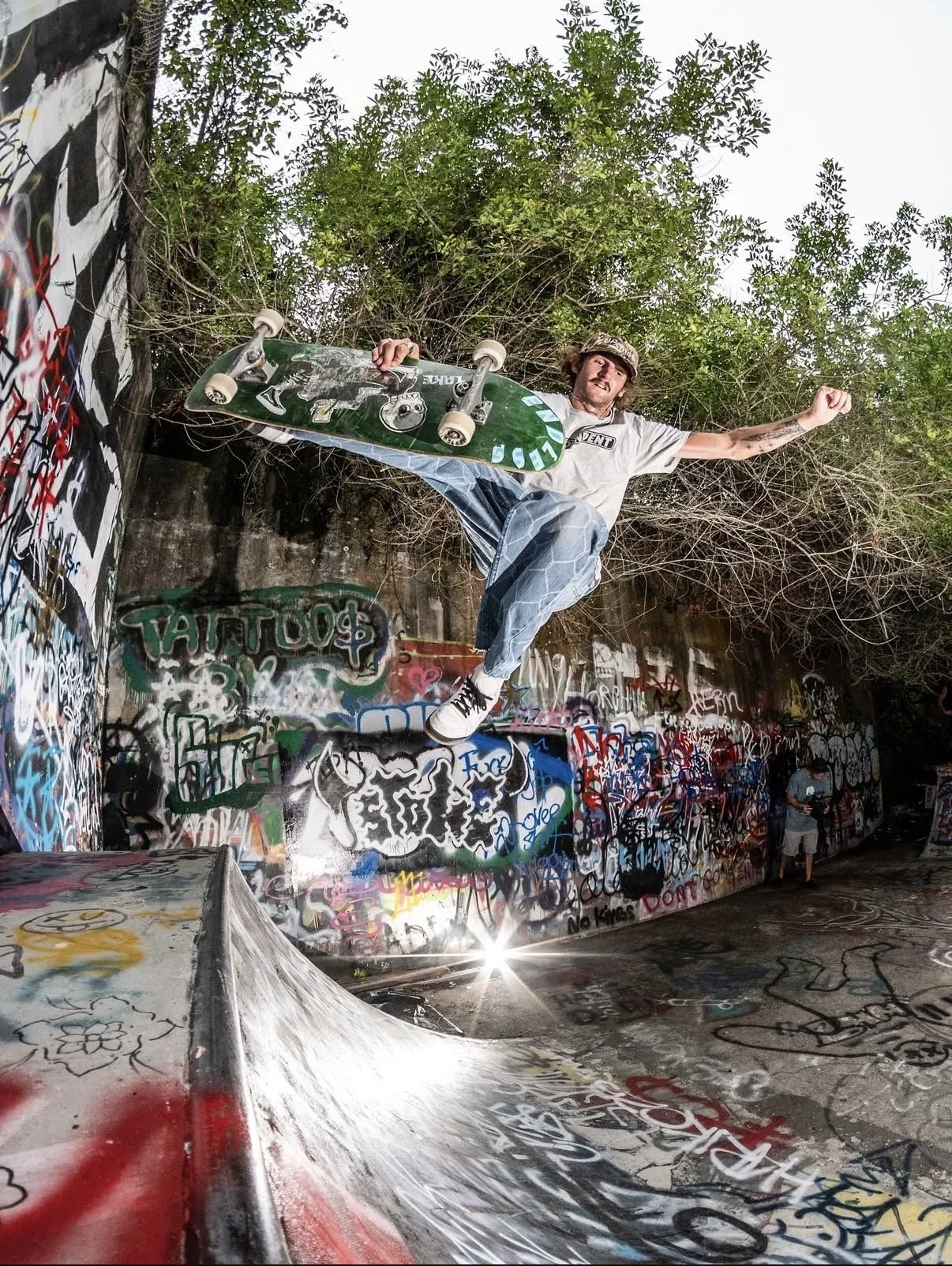 Threadline team member Nick Day skateboarding a graffiti-covered concrete spot, capturing raw skate culture, creativity, and street-level energy.