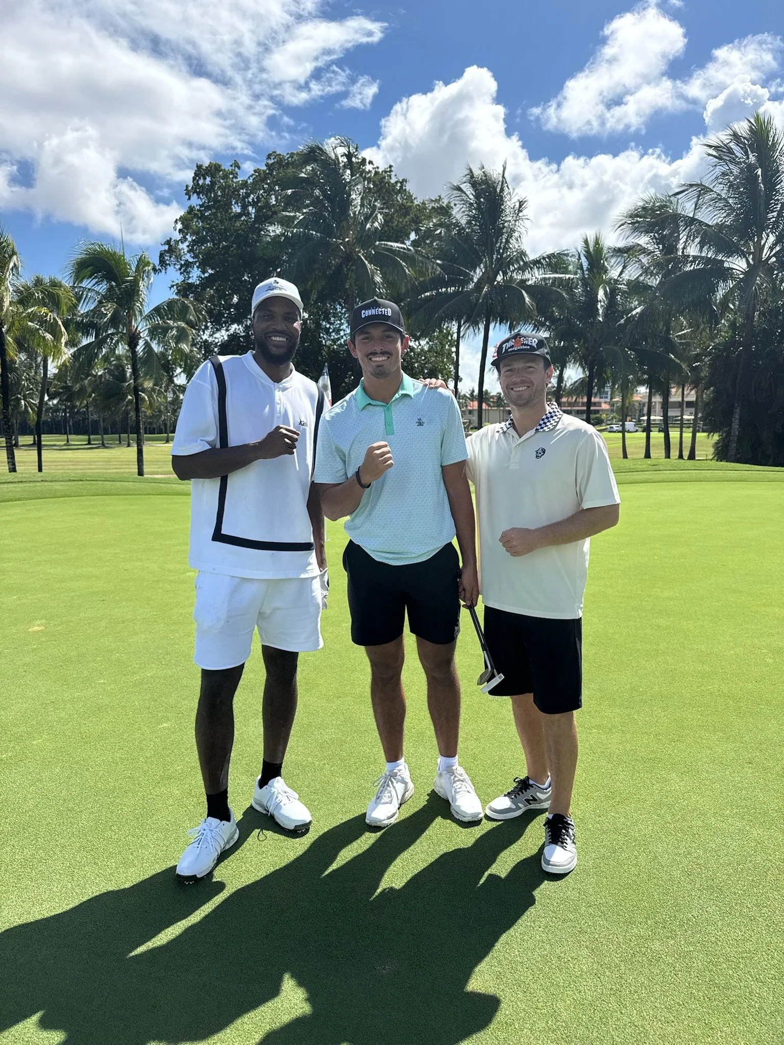 Malik Beasley and The Connected Golfer with Threadline Collective Founder Dillon Denardo at Trump Doral Golf Course on a bright sunny day with a few cloud in the background