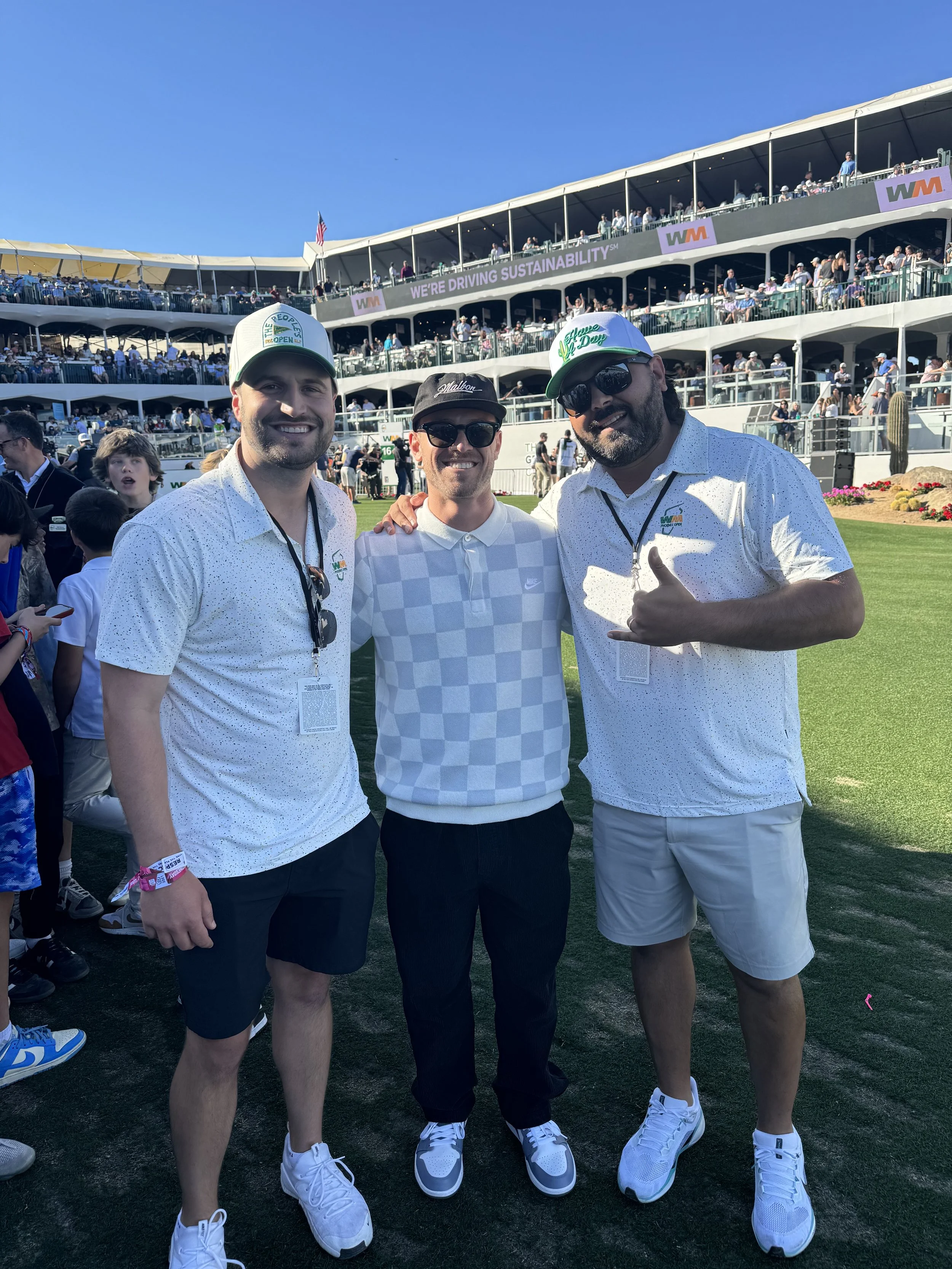 Bob Does Sports and Joey Cold Cuts surround Dillon Denardo on the tee box of the 16th hole at the Waste Management Open on Celebrity Day