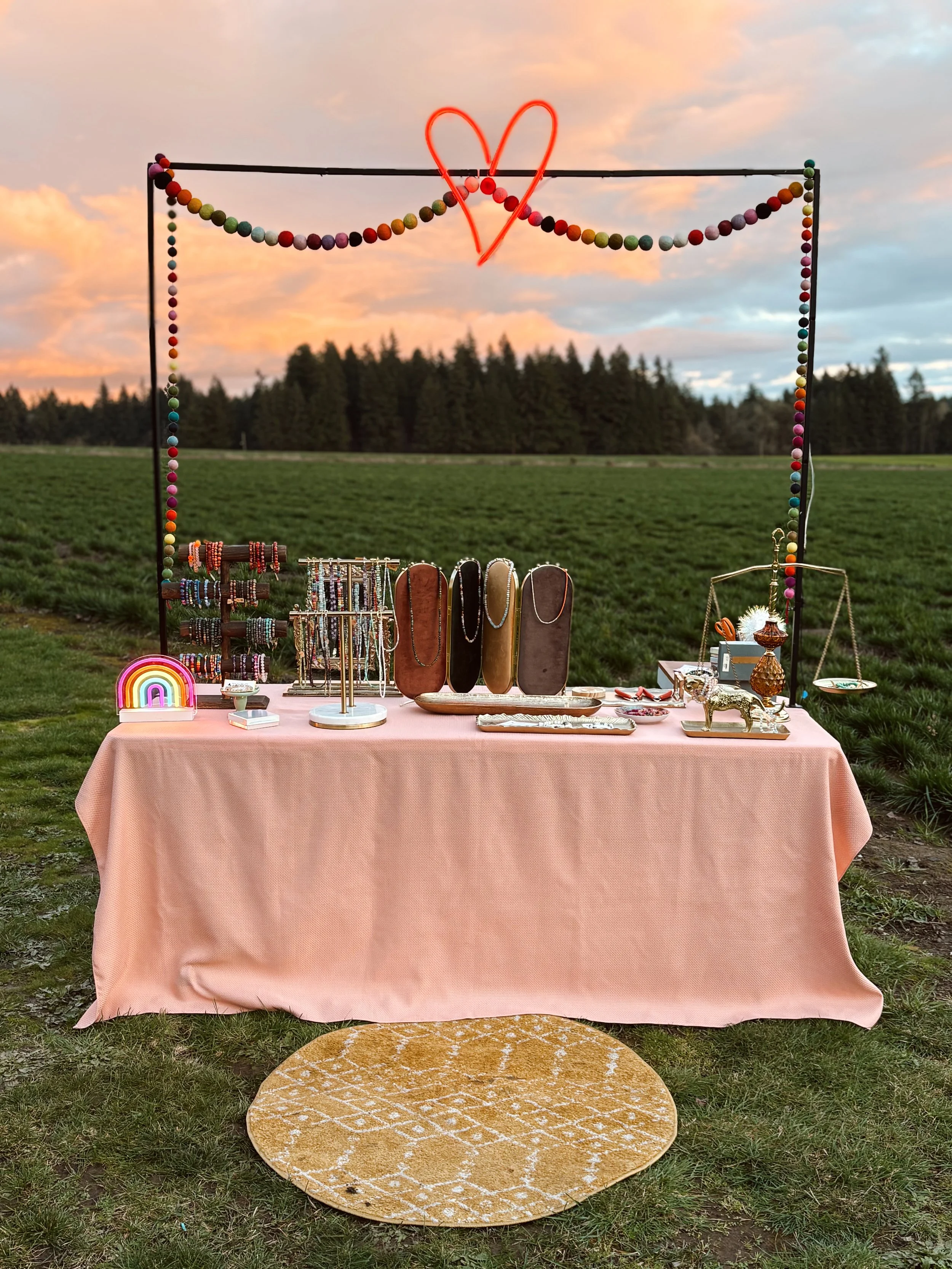 Garden Party pop up design. As the clouds above transformed into the color palette for the arrangement - We love activating in unique and unexpected places, and are fully self contained for a touch of cozy, neon glow in the abundance of mother nature