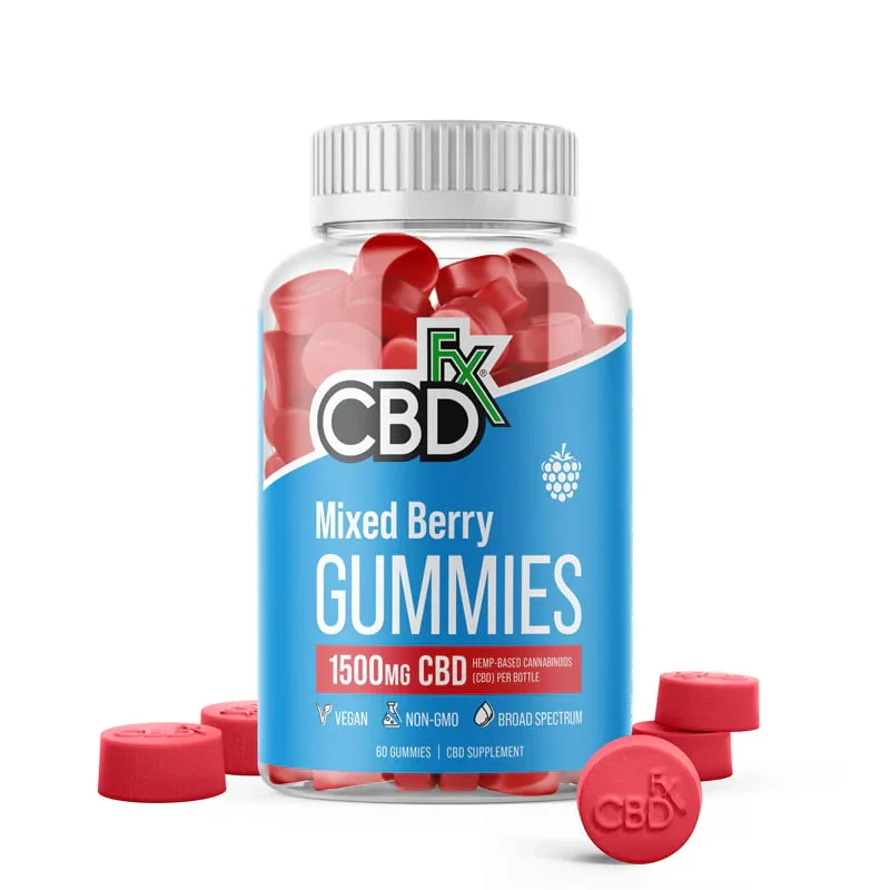 Bottle of mixed berry CBD gummies with some gummies outside the bottle and a few caps scattered around.