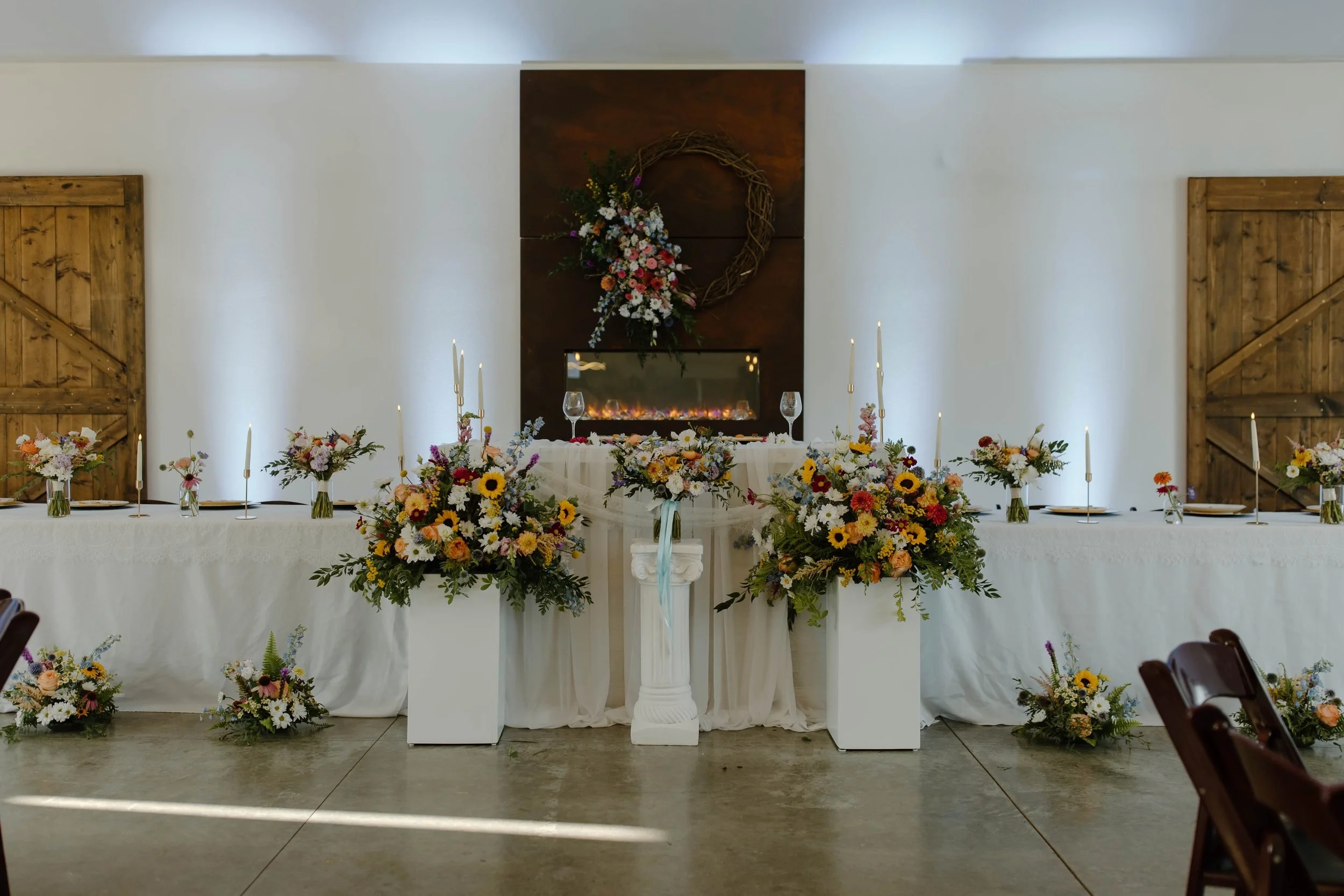All of Eric and Anna&rsquo;s ceremony floral was repurposed to their reception. Well, that was the plan anyway! The weather had other ideas! There was only a small break in the rain that day and instead of taking all of the arrangements down to the c