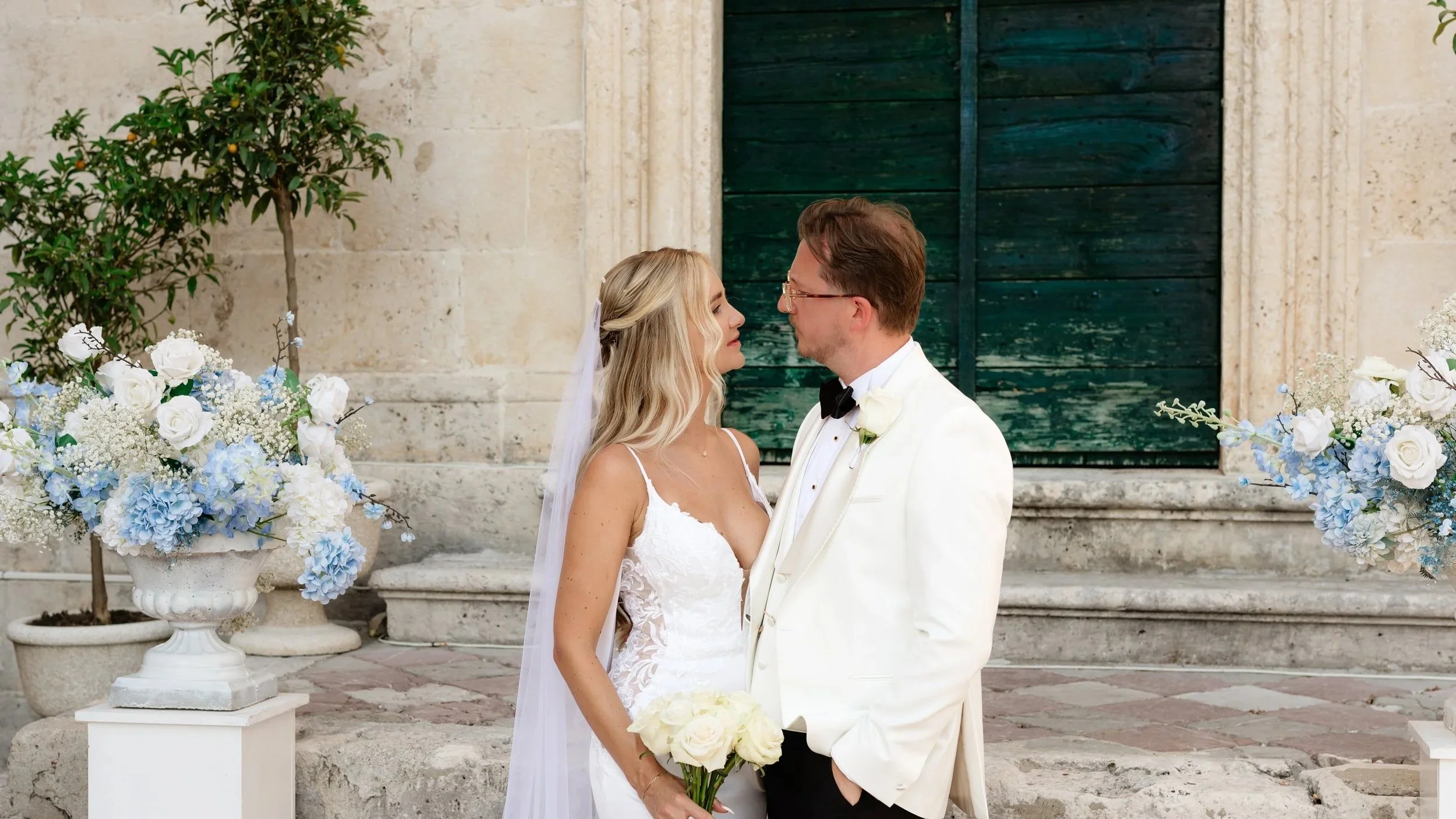 couple's intimate moment on piazza square at hgp in front of the church's green doors