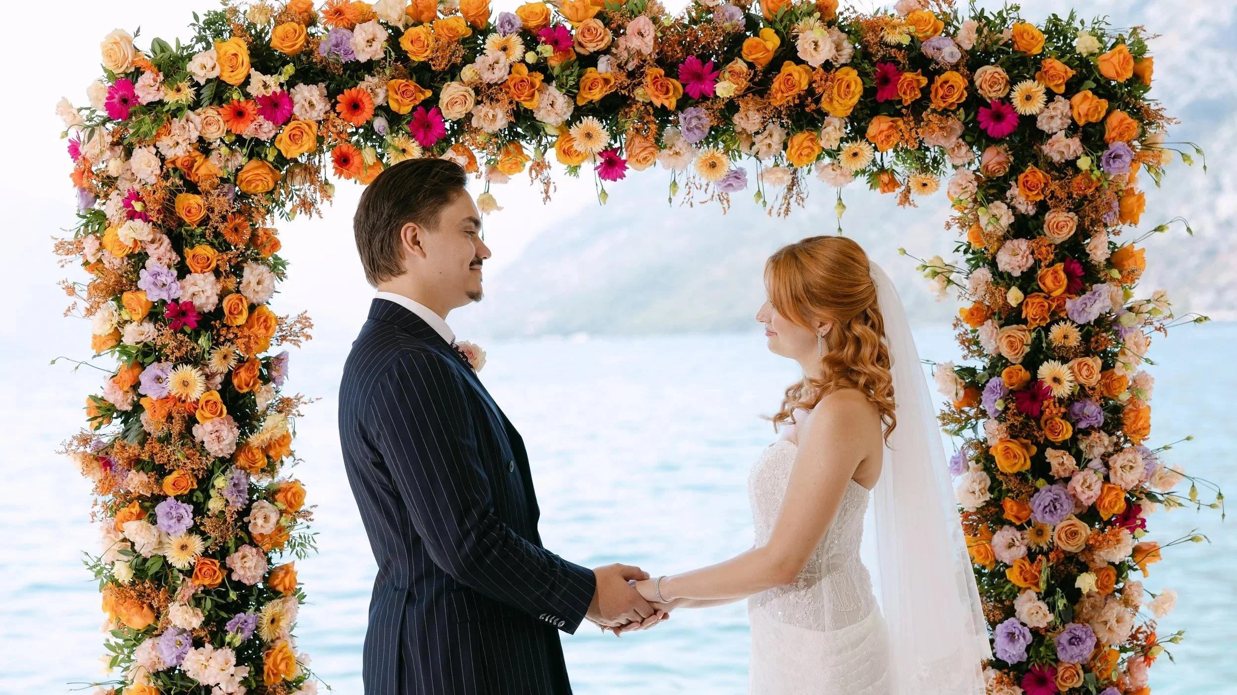 ceremony with kotor mountans and water background