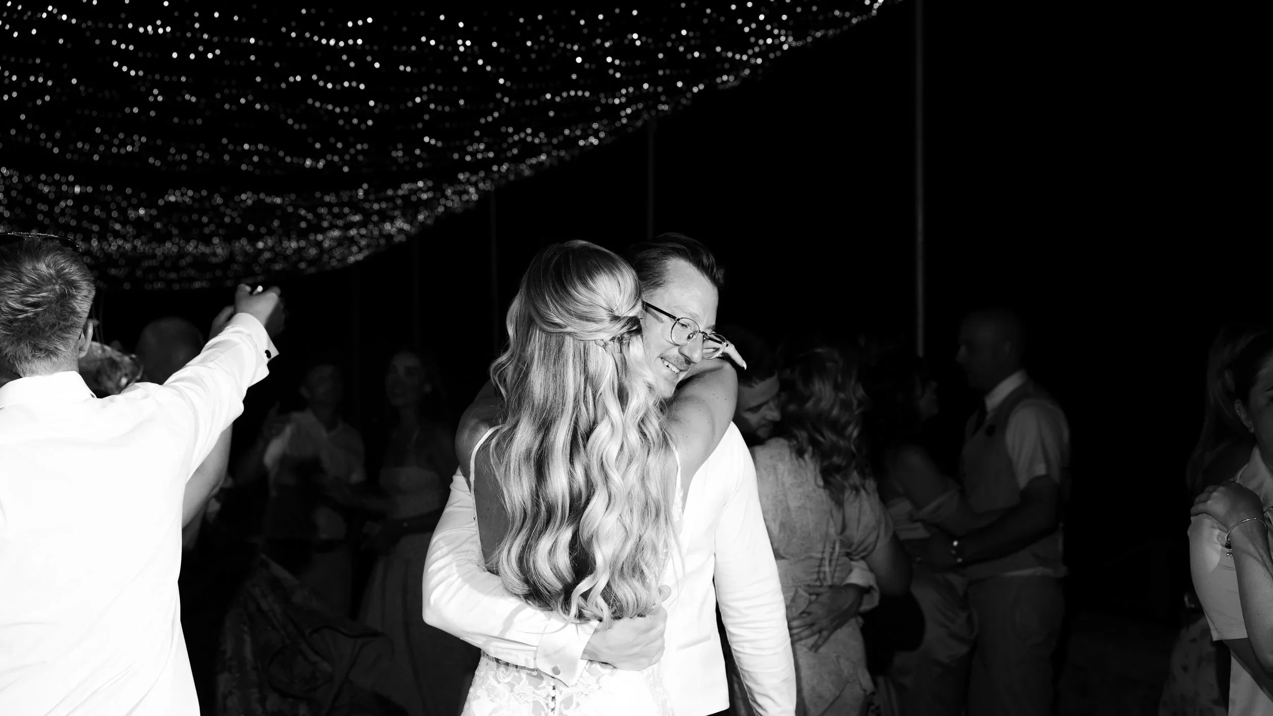 couple's first dance at the panoramic terrace below the fairy lights