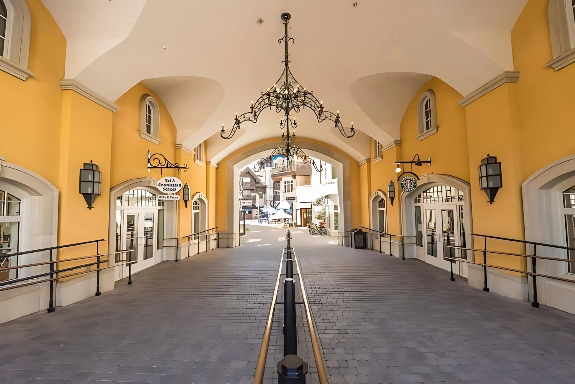 East pedestrian portal at the Arrabelle at Vail Square.  Vaulted plaster ceiling with decorative chandelier.