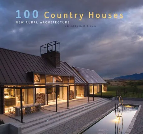 Cover of a book titled '100 Country Houses: New Rural Architecture,' showing a modern country house with large glass windows, a metal roof, a chimney, an outdoor patio area, and a swimming pool under a cloudy sky.