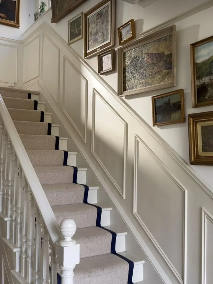 Neautral Staircase wit hanging pictures, Wall Display of picture frames along the stairs.