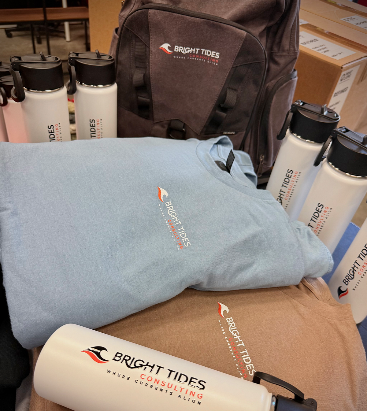 Close-up of a Centrios branded jacket with a zipper, laying on a surface with other clothing and a bag.
