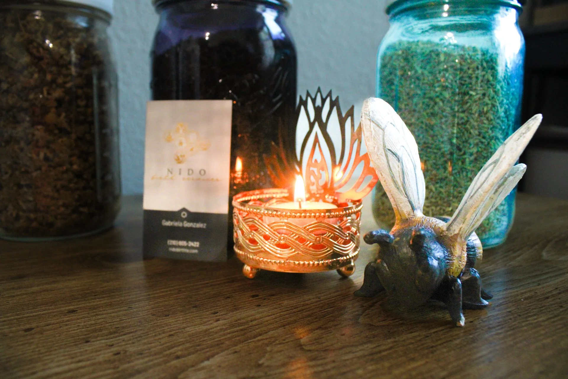 Decorative bumblebee figurine with bee wings and a jar filled with dried herbs. In Austin, Texas.