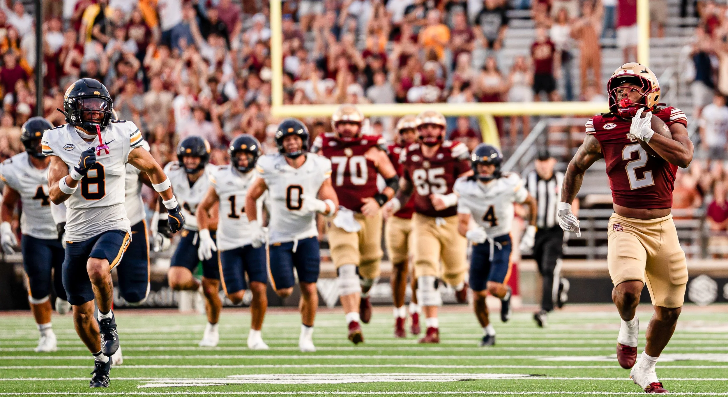 CHESTNUT HILL, MASSACHUSETTS – SEPTEMBER 27: Running back Turbo Richard #2 sprints downfield for a touchdown against Cal as the crowd erupts in celebration at Alumni Stadium. (Photo by Max Elliot/BC Football)