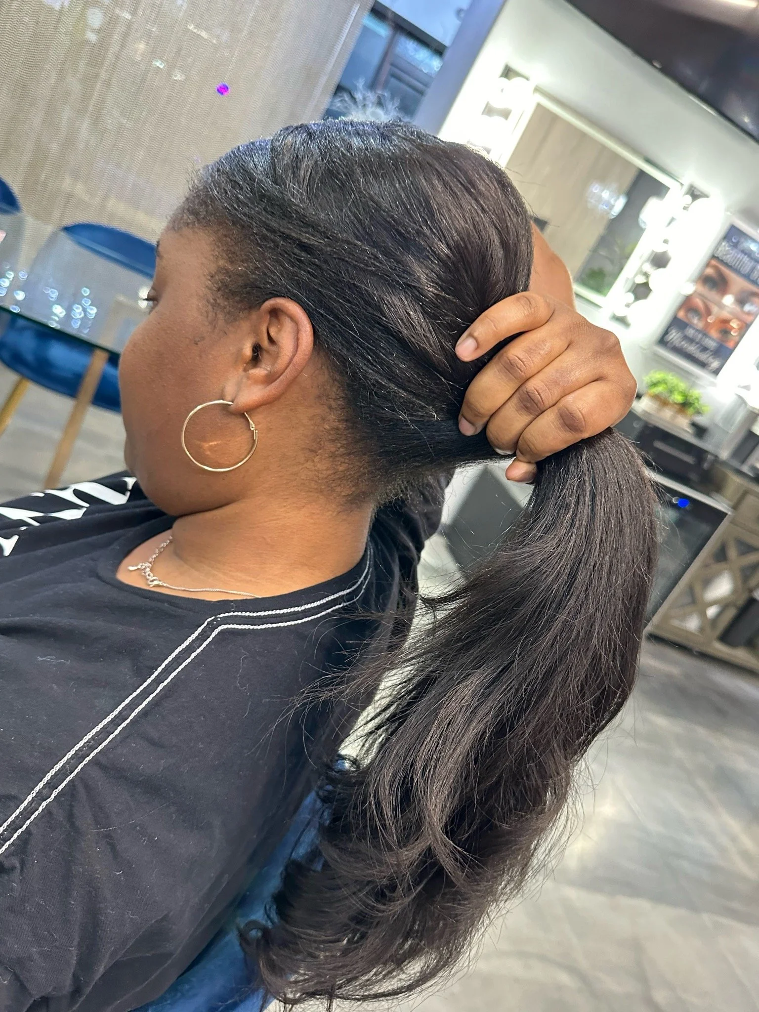 Woman holding out the stretched portion of her hair.jpg