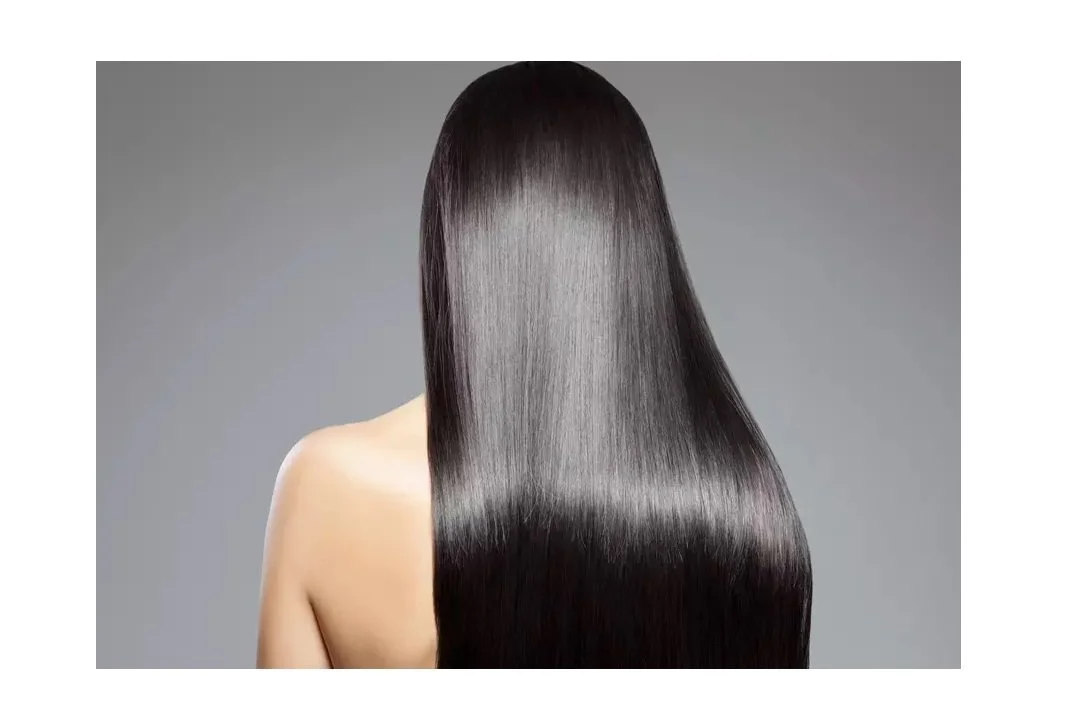 YUKO Japanese Hair Straightening - Back view of woman with long, straight, shiny black hair against gray background.