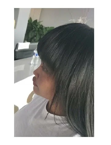 A woman wearing a beautifully adorned weave-on.jpg