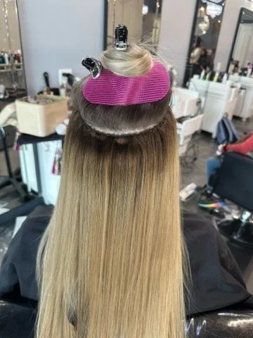 A woman with hair being weaved-on to her.jpg