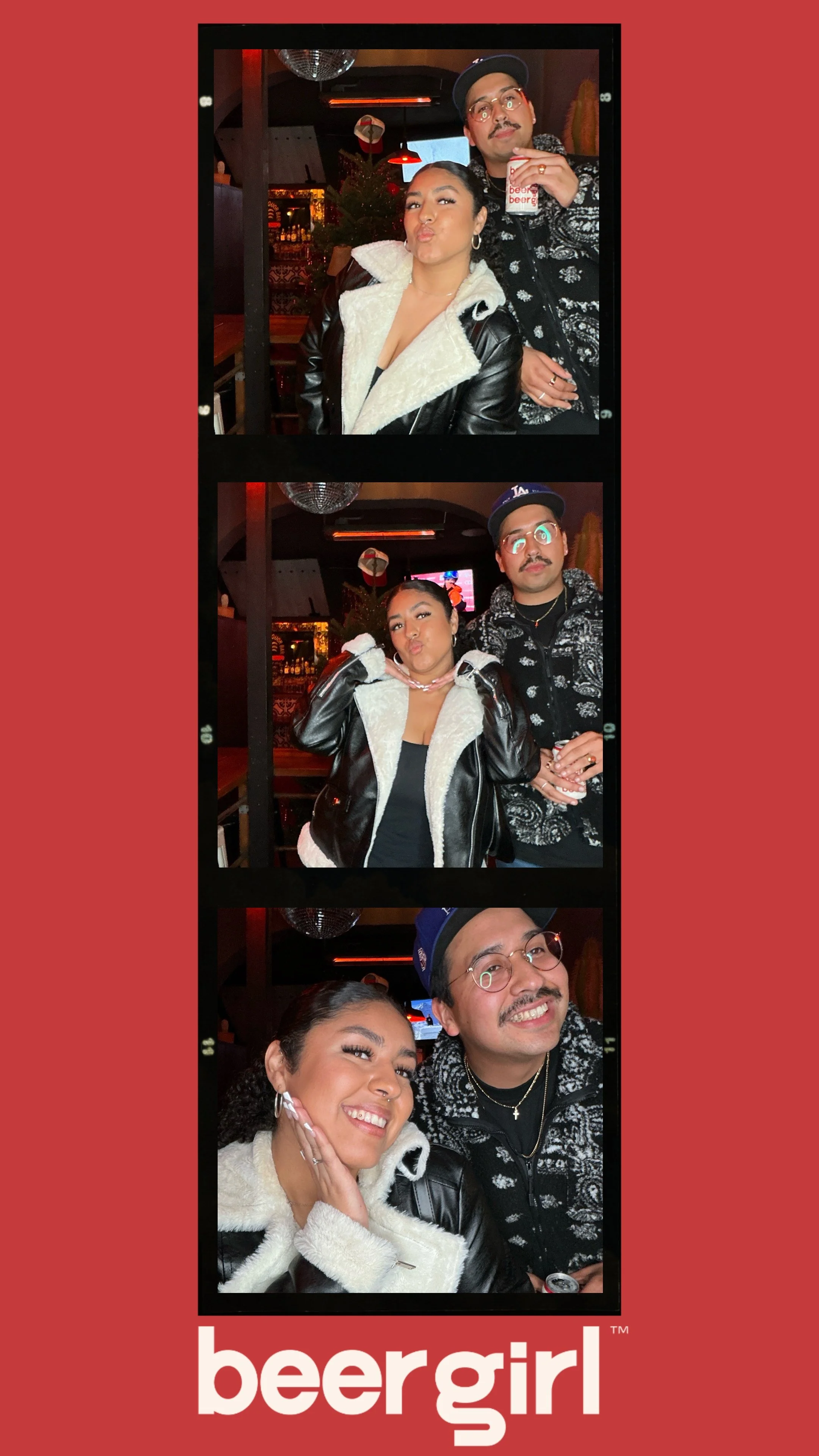 Photo booth strip with two people posing, in a bar with red lighting and Christmas decorations, wearing winter clothing, and holding a cup. 'Beergirl' logo at the bottom.
