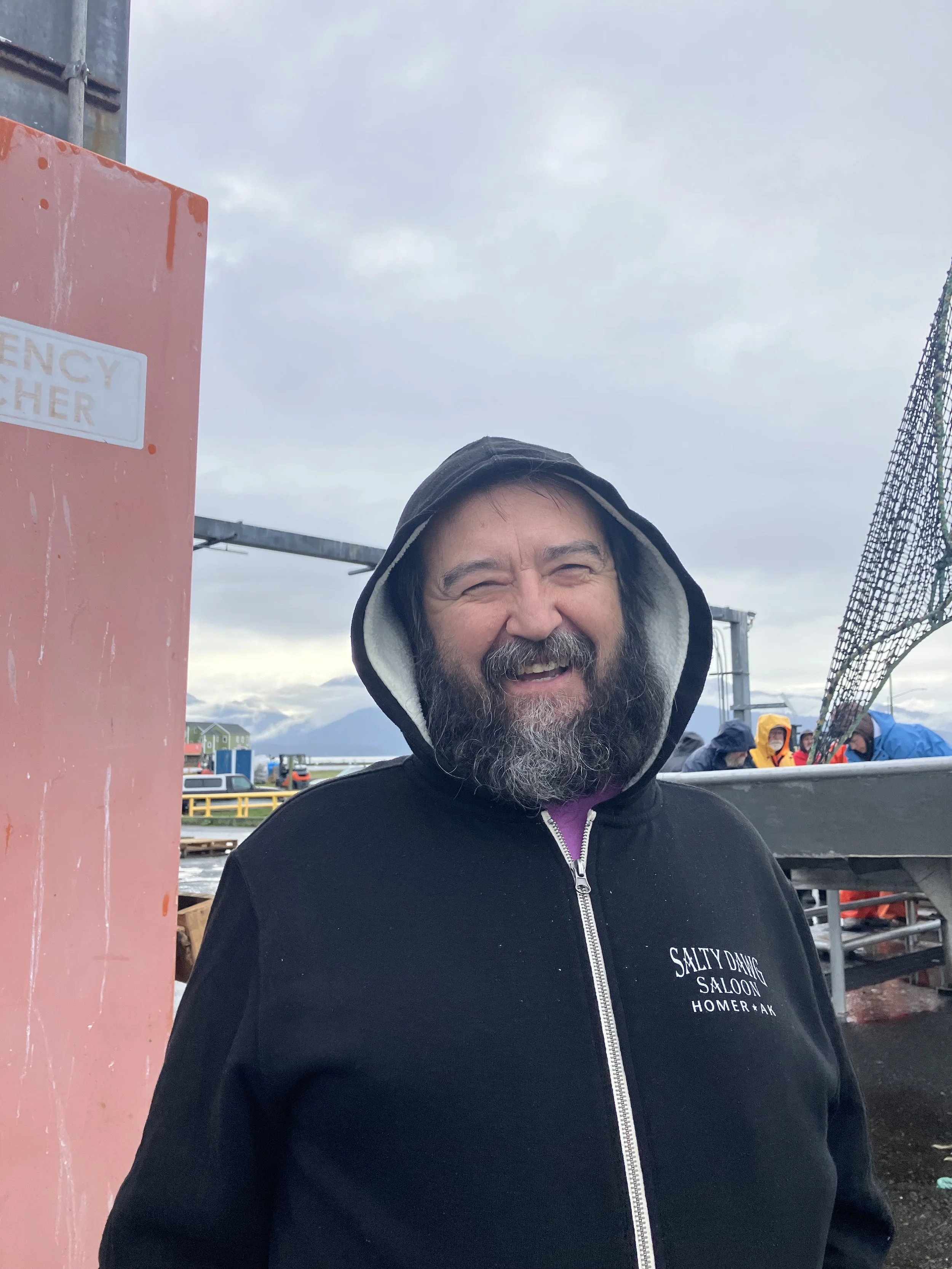 Happy fisherman holding Halibut he caught off of Homer, Alaska