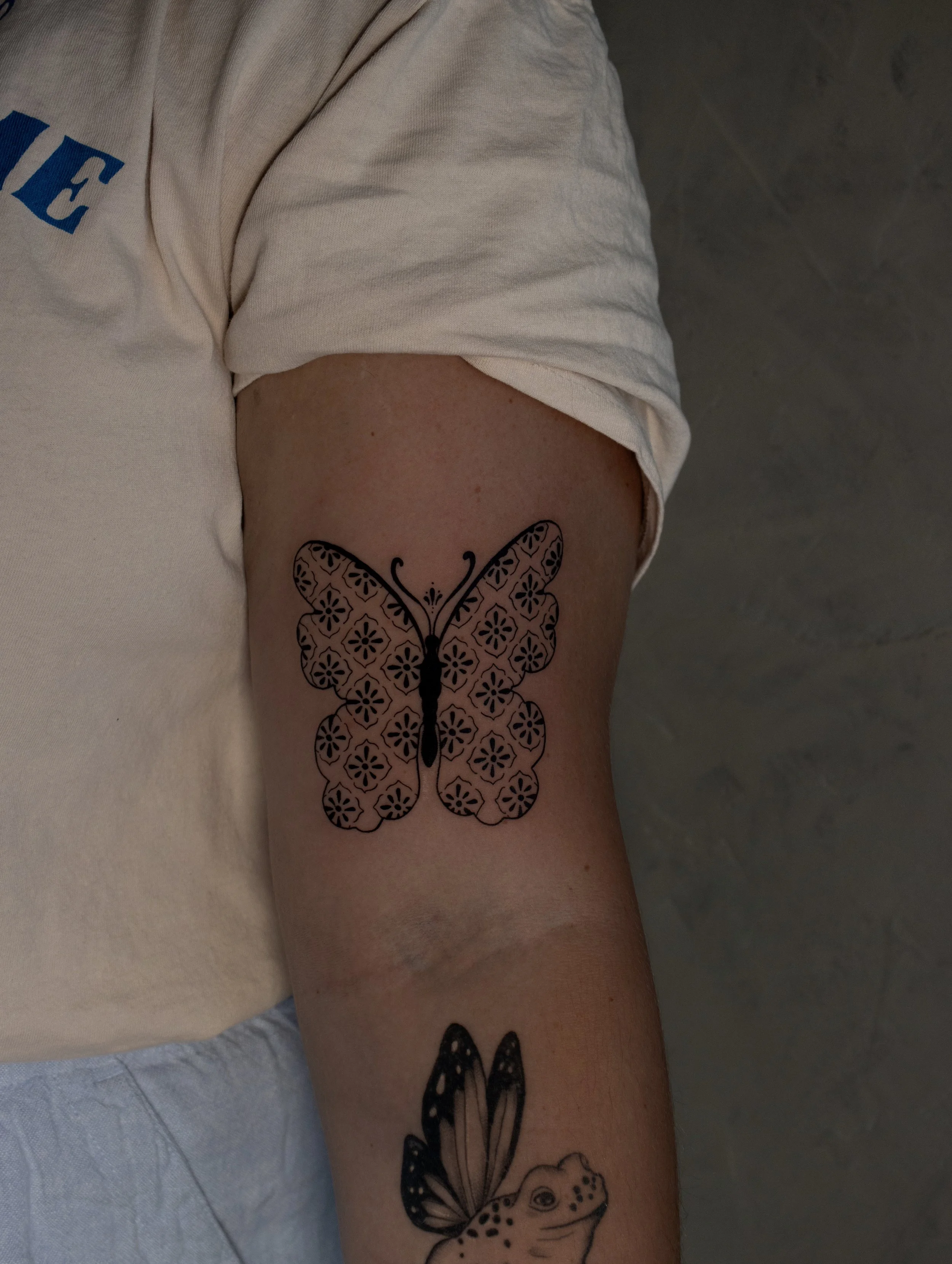 Fine line Butterfly tattoo with minimalist geometric pattern on the arm - small tattoo created by Erica Inagaki in Lakewood Colorado