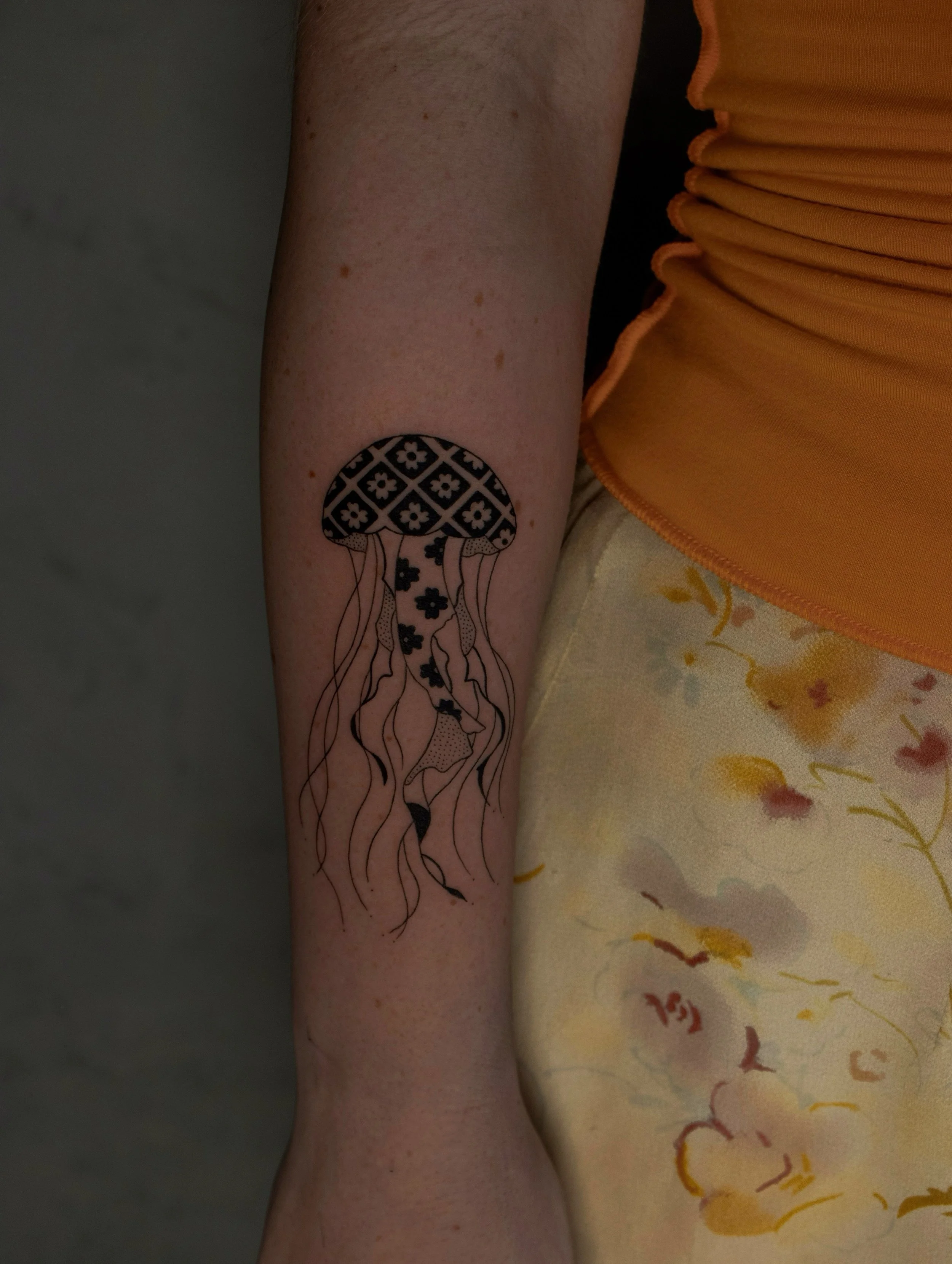 Fine Line Jellyfish tattoo with geometric pattern on the forearm - small cute tattoo created by Erica Inagaki in Arvada Colorado