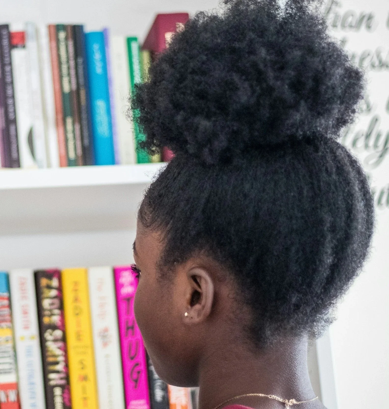 Child looking at a bookshelf