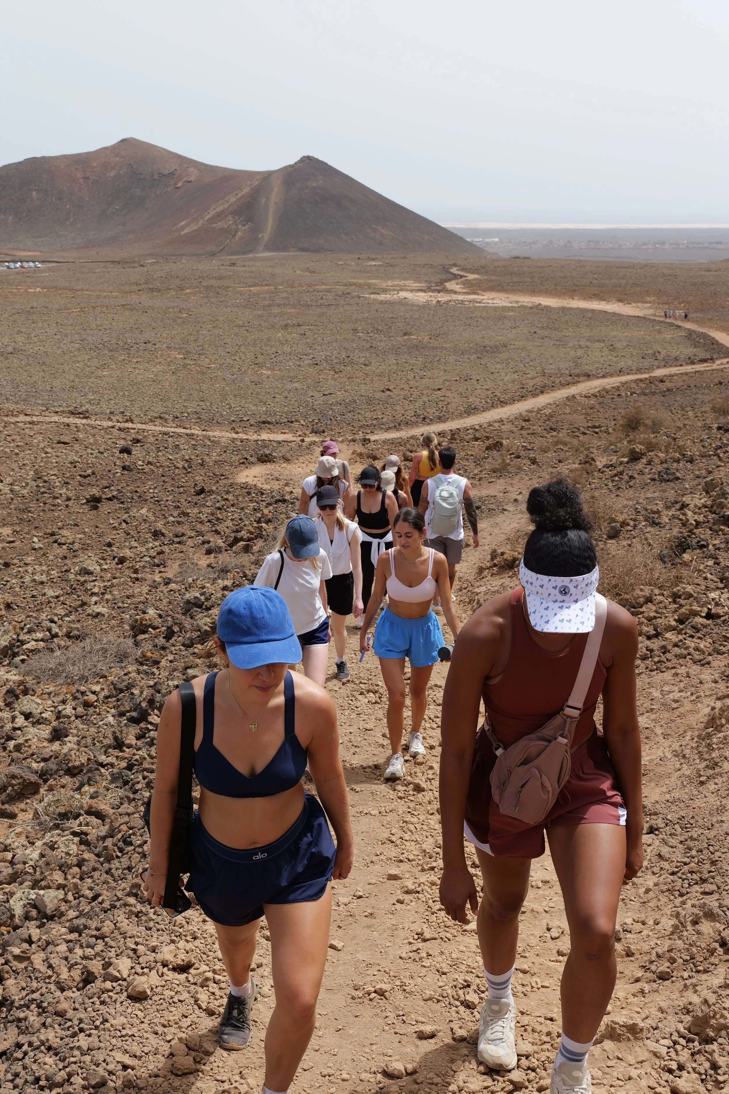 Group hiking on a rocky trail during a Held Retreats wellness retreat