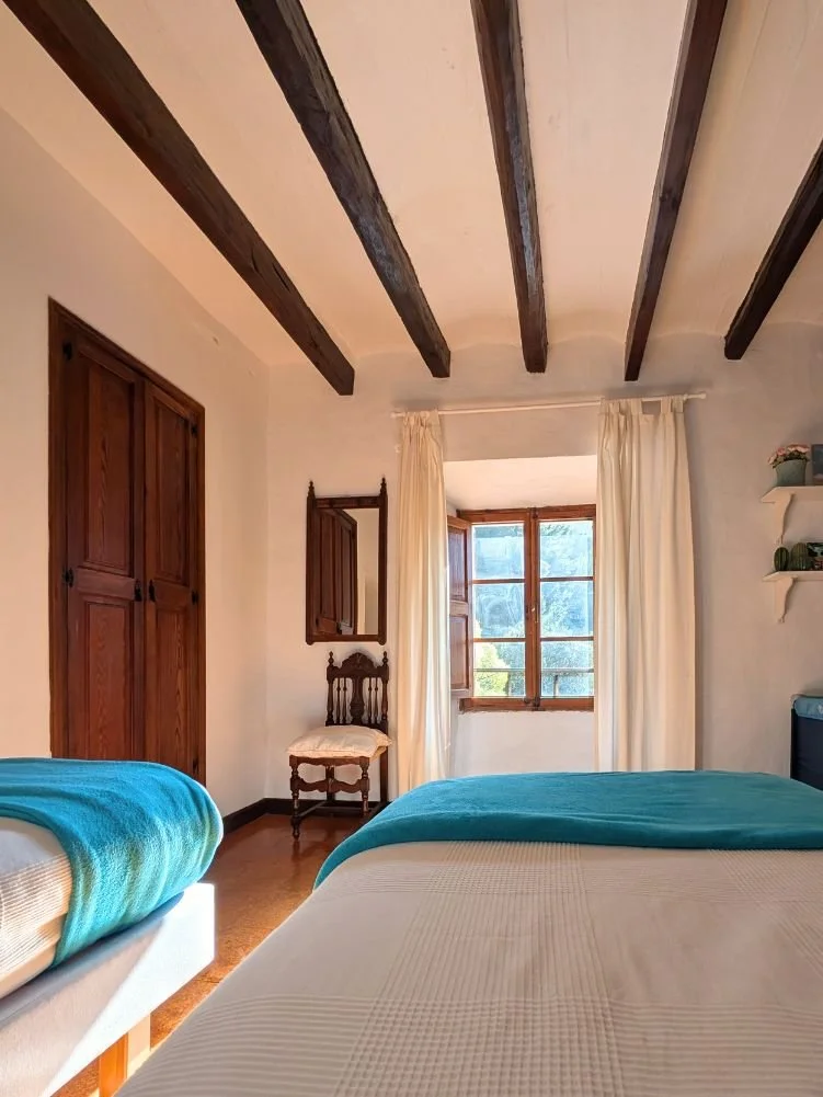 Bright and cozy twin bedroom during a Held Retreats wellness retreat