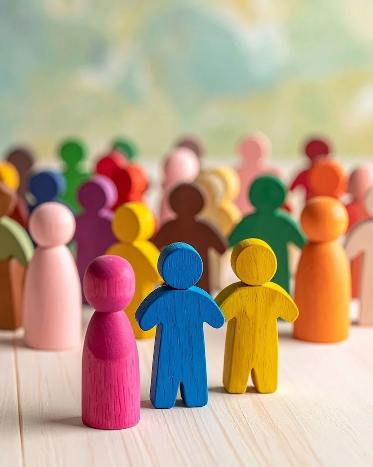 Colourful wooden people together representing the Not Winging It Leadership Club.