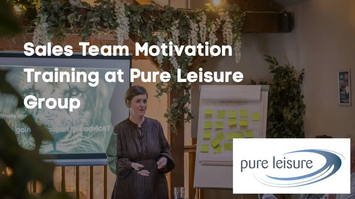 Image of Sharon Smith wearing a brown dress presenting to a team of sales people at Pure Leisure Group - an example of leadership case studies