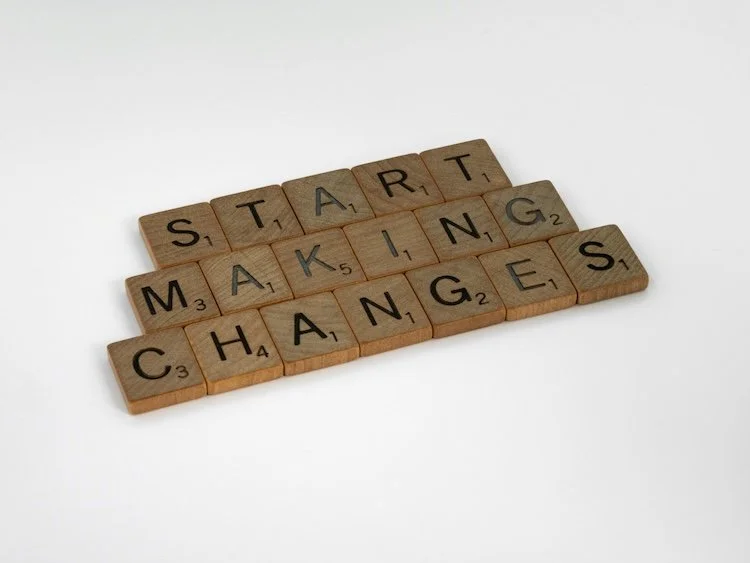 Wooden scrabble pieces that say start making changes.