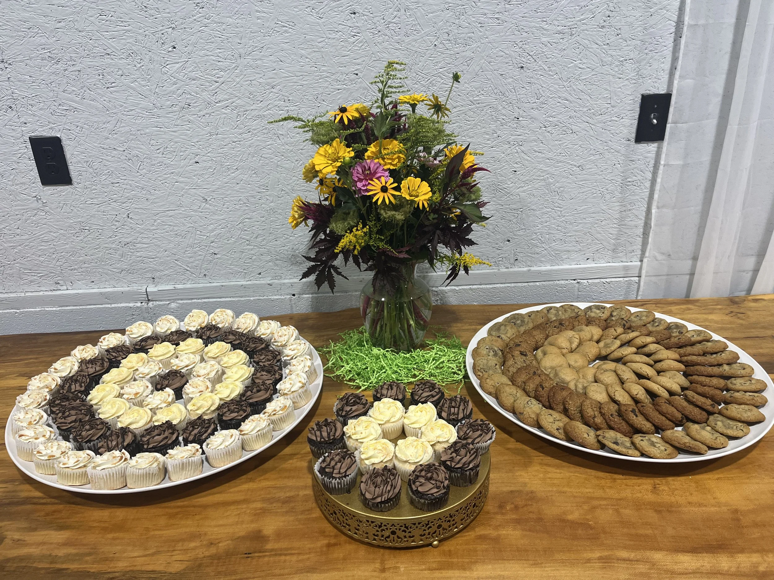 Dessert Table with cupcakes, cookies, and florals