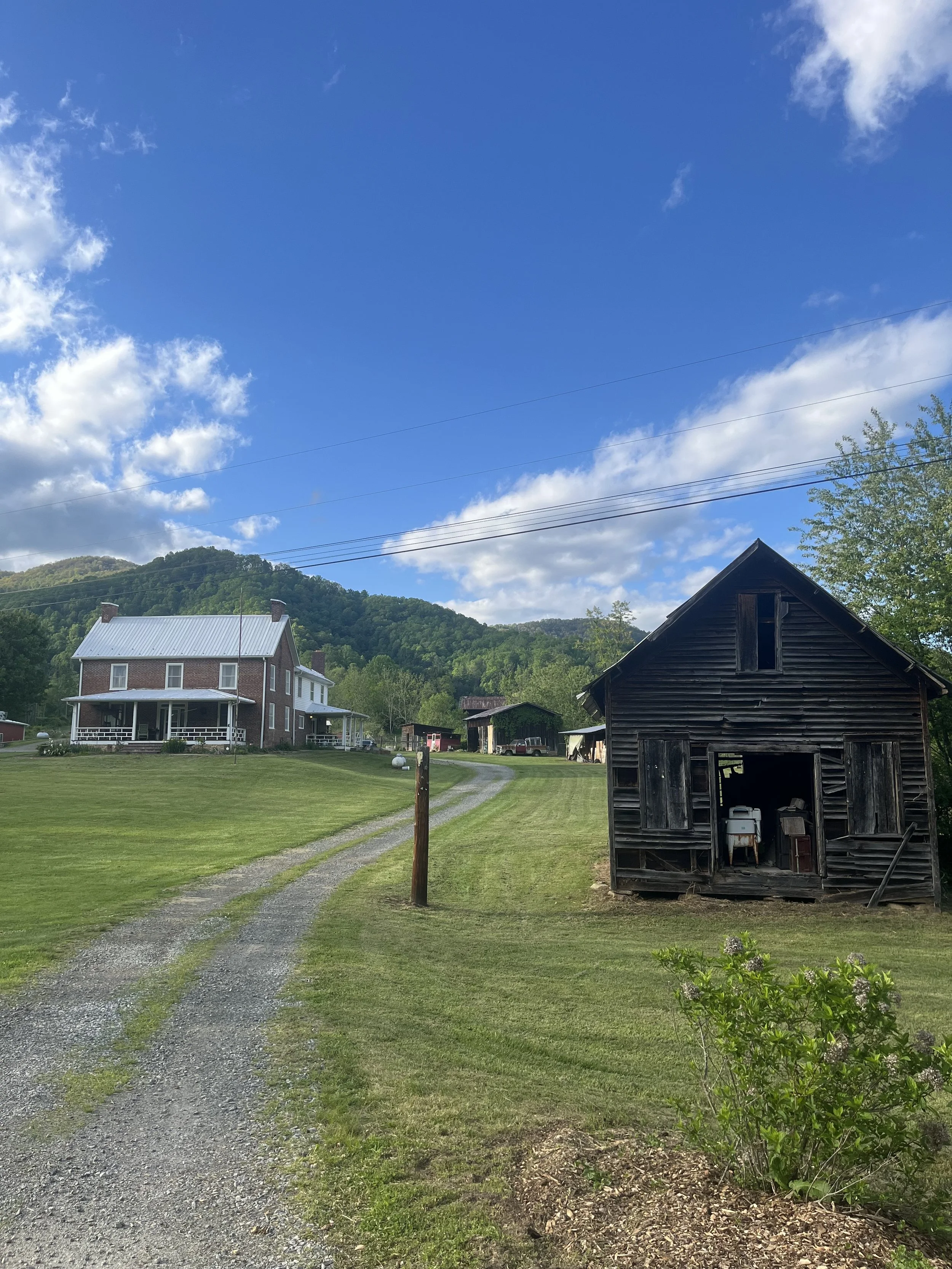 View of Cornelia's Place Historic Farmhouse and old Storehouse from the end of the Driveway